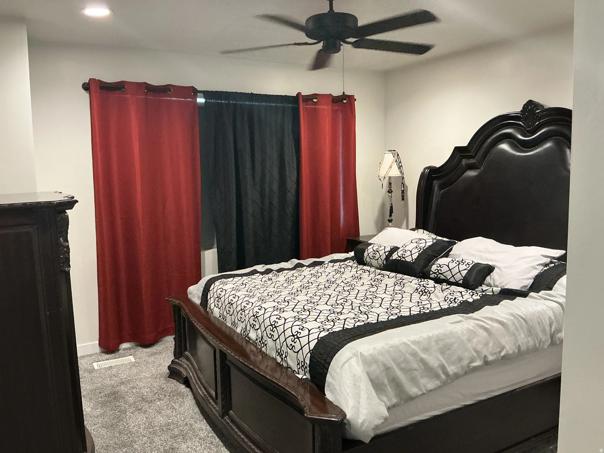 Bedroom with light carpet and ceiling fan