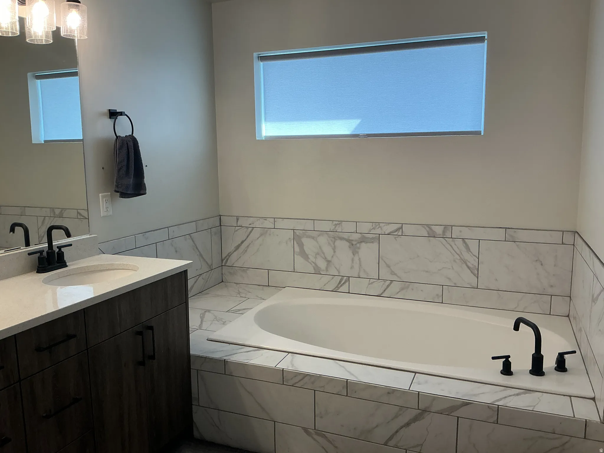 Full bath with vanity and a bath