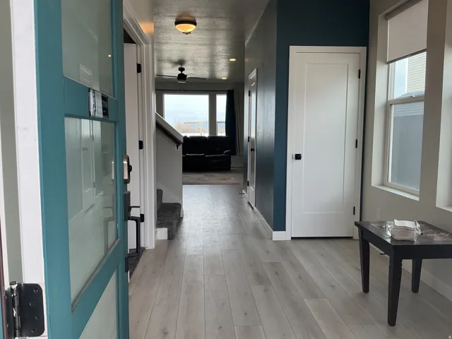 Hallway with stairway and light wood-style floors