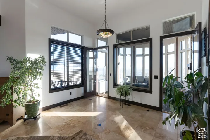 Entryway with baseboards and a high ceiling