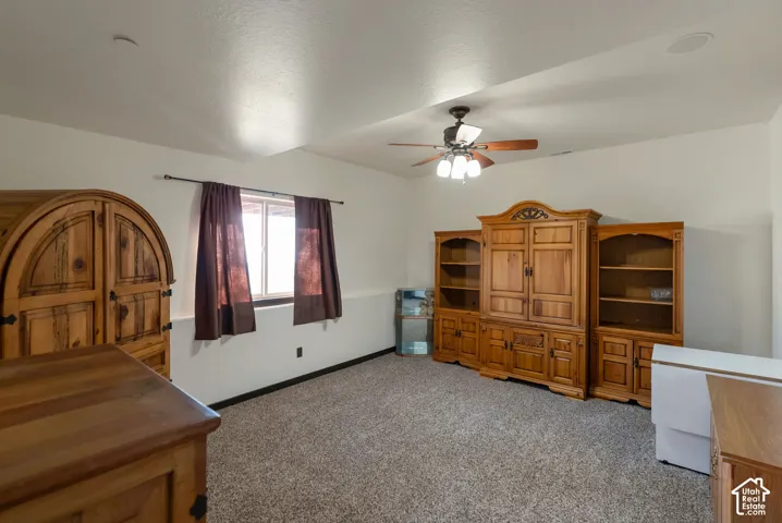 Bedroom featuring light colored carpet and ceiling fan