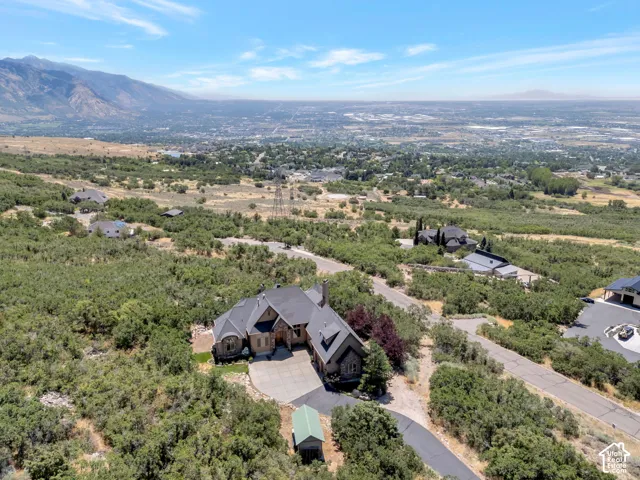 Spacious property featuring a stone and stucco exterior, multiple rooflines, and an attached garage with a paved driveway