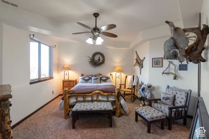 Bedroom with carpet and a ceiling fan