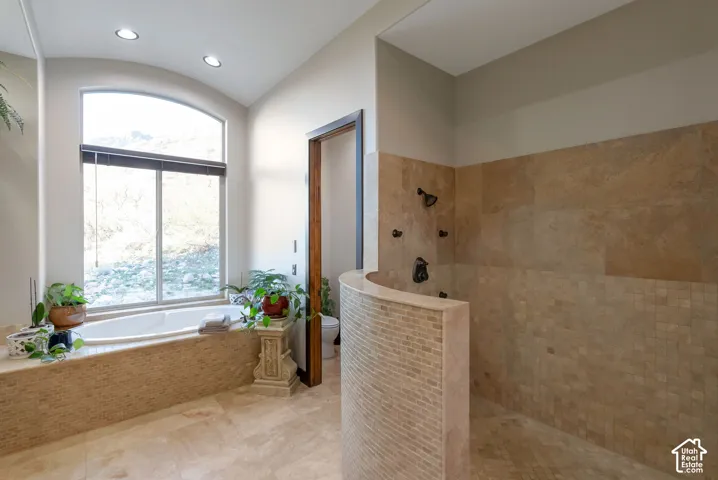 Full bath featuring a walk in shower, a garden tub, and recessed lighting
