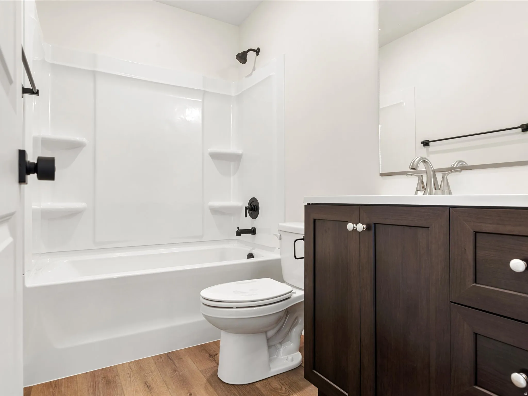 Full bath featuring vanity, light wood-style floors, and shower / bathtub combination