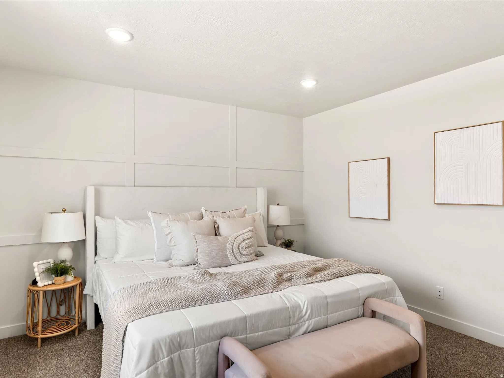 Carpeted bedroom featuring a decorative wall and recessed lighting
