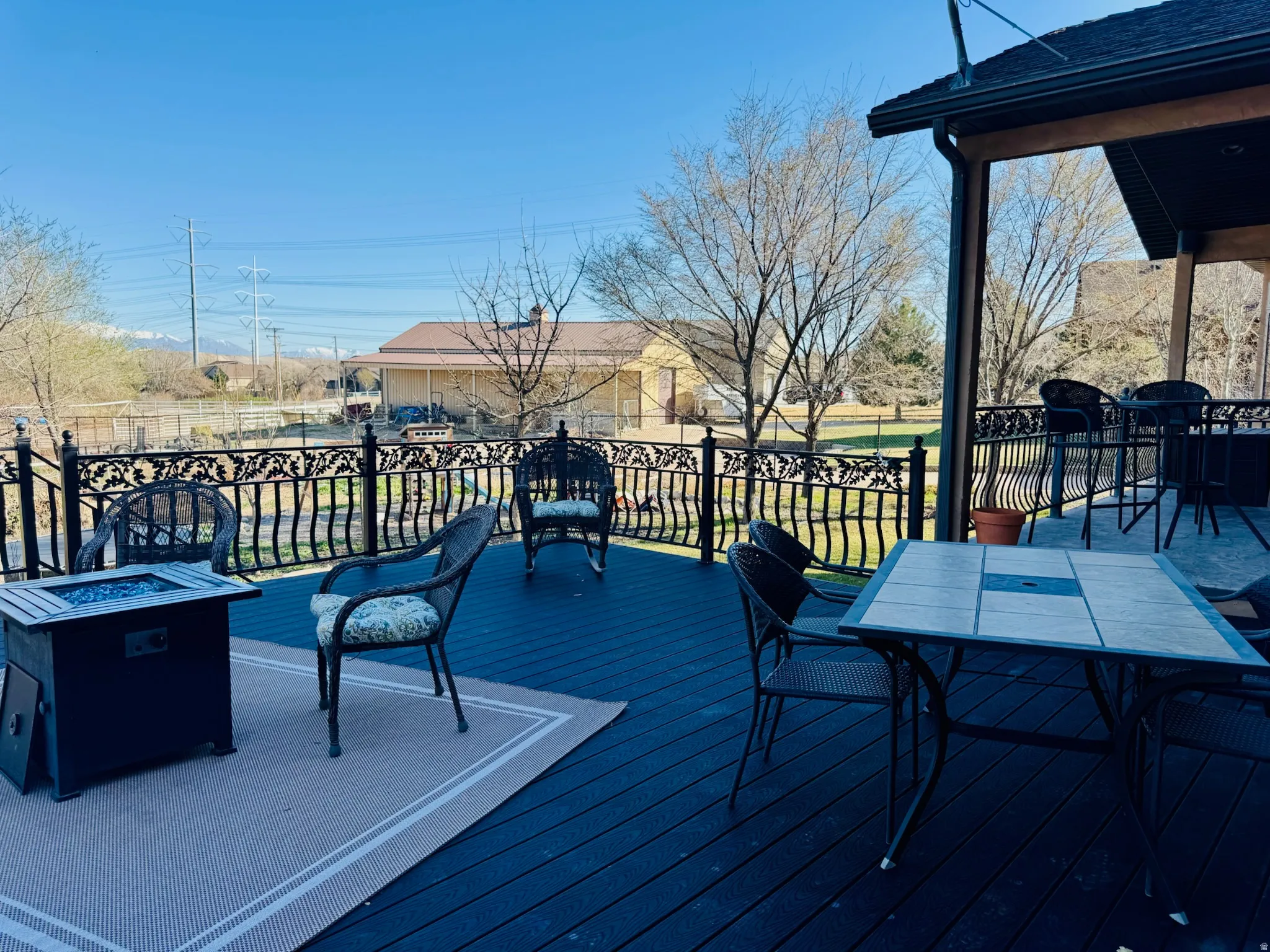 Wooden deck with a fire pit and outdoor dining space