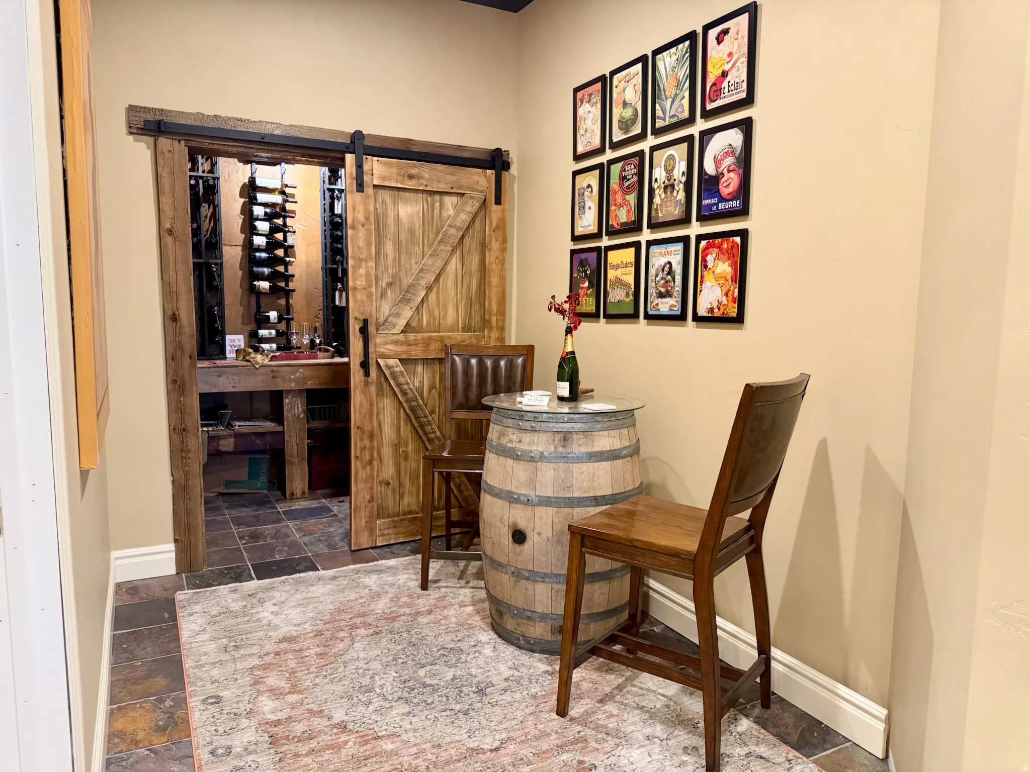 Wine room with a barn door and stone tile floors