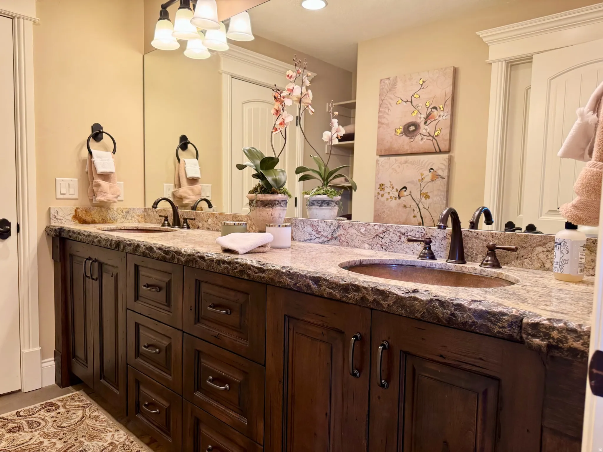 Bathroom featuring double vanity and suspended lighting