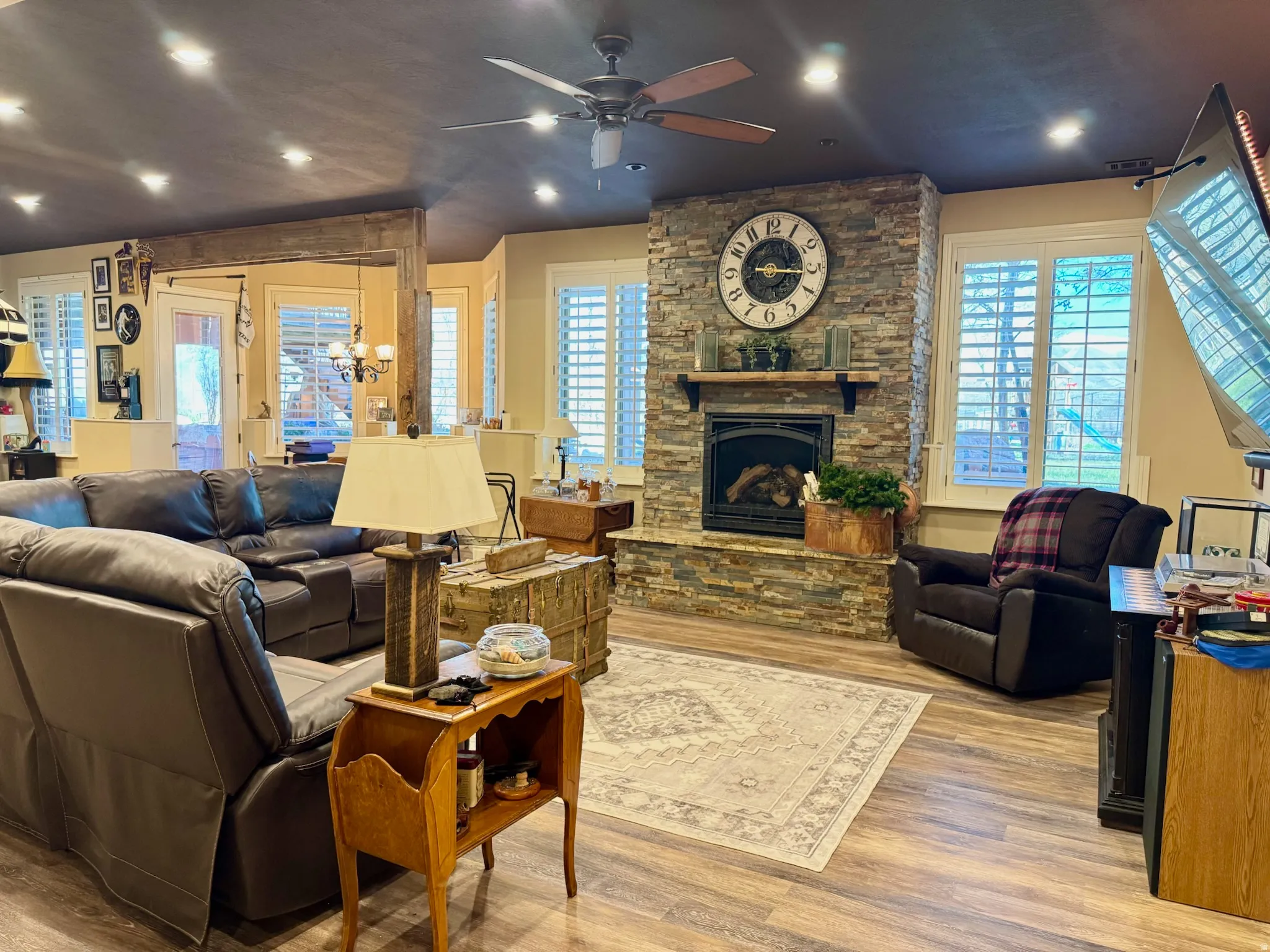 Living area featuring recessed lighting, light wood finished floors, a fireplace, plenty of natural light, and ceiling fan