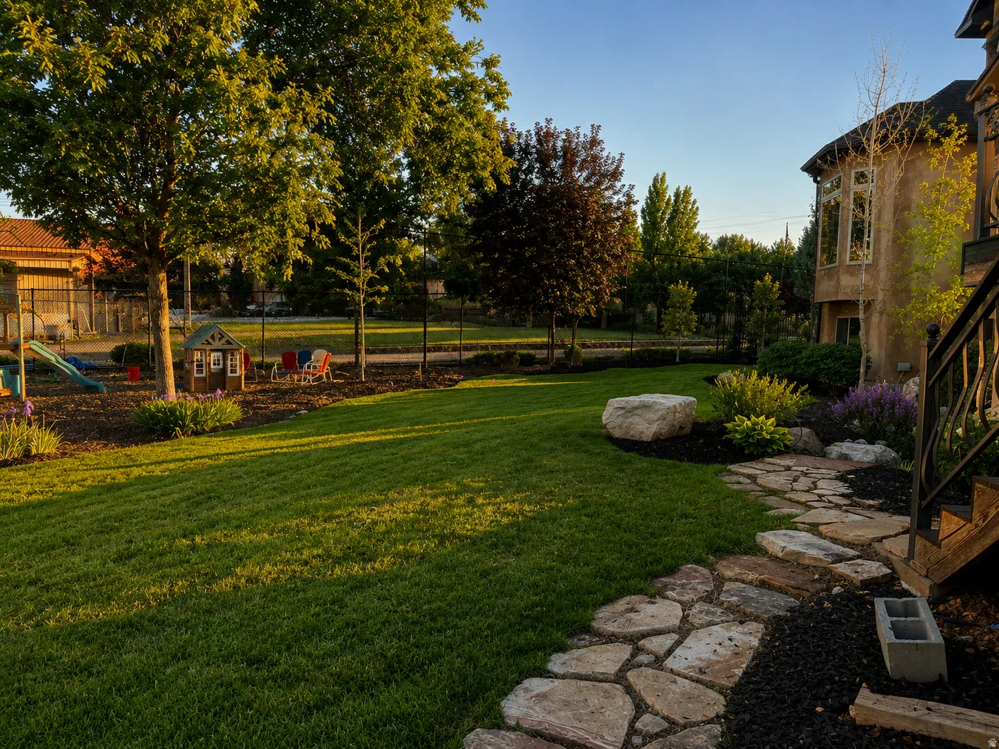 Expansive grassy lawn with a natural stone pathway