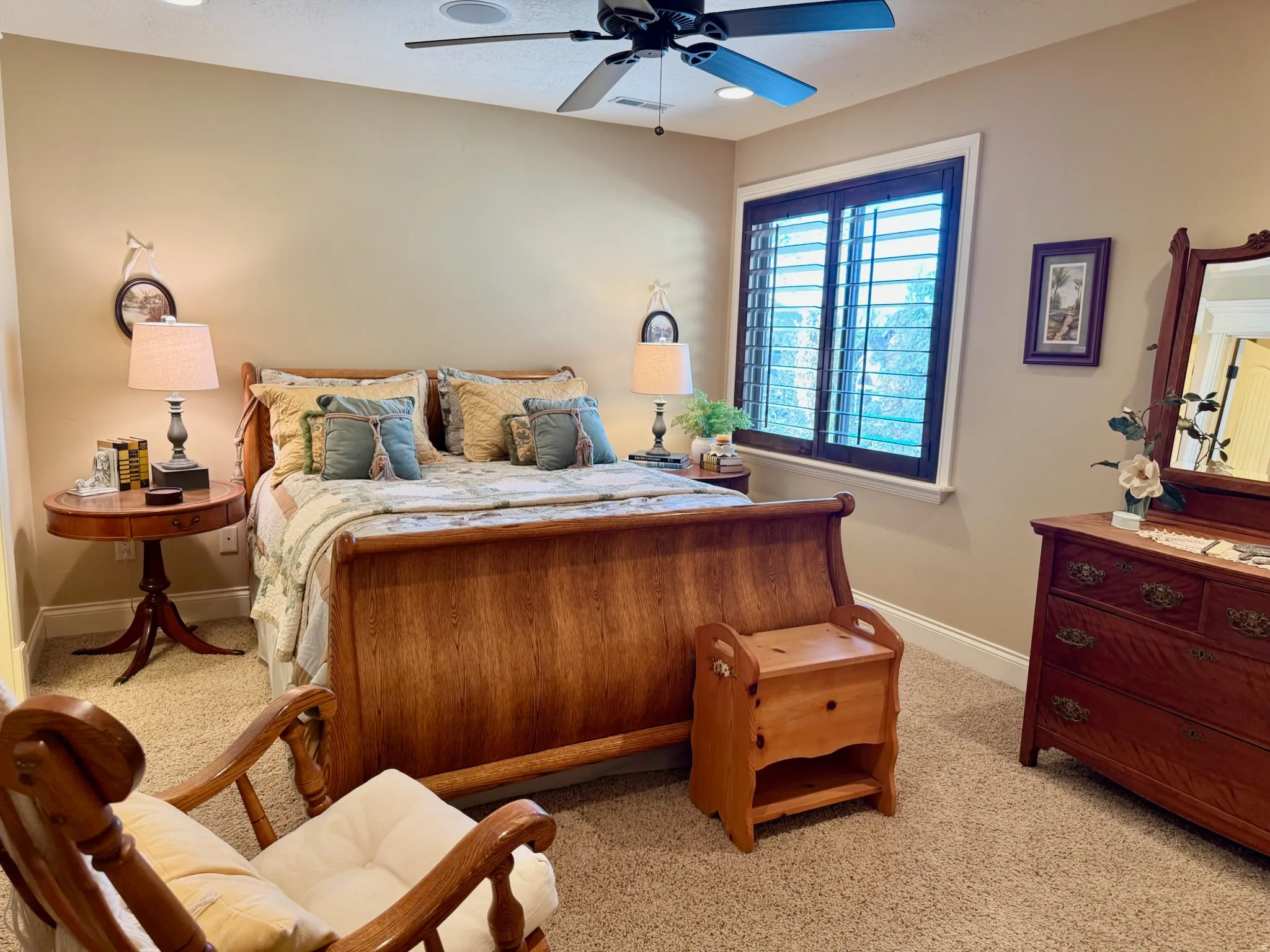 Bedroom with light colored carpet and ceiling fan