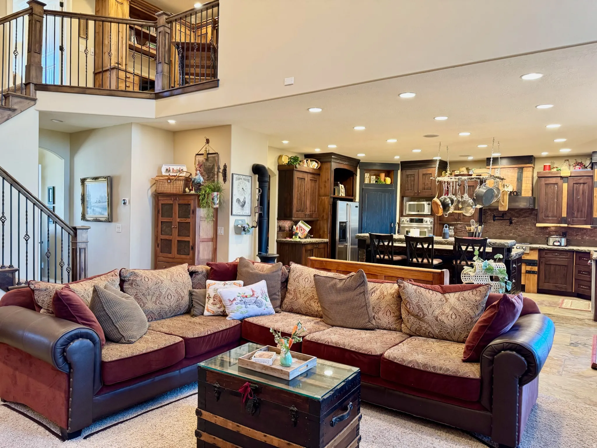 Living area featuring recessed lighting, a high ceiling, and arched walkways