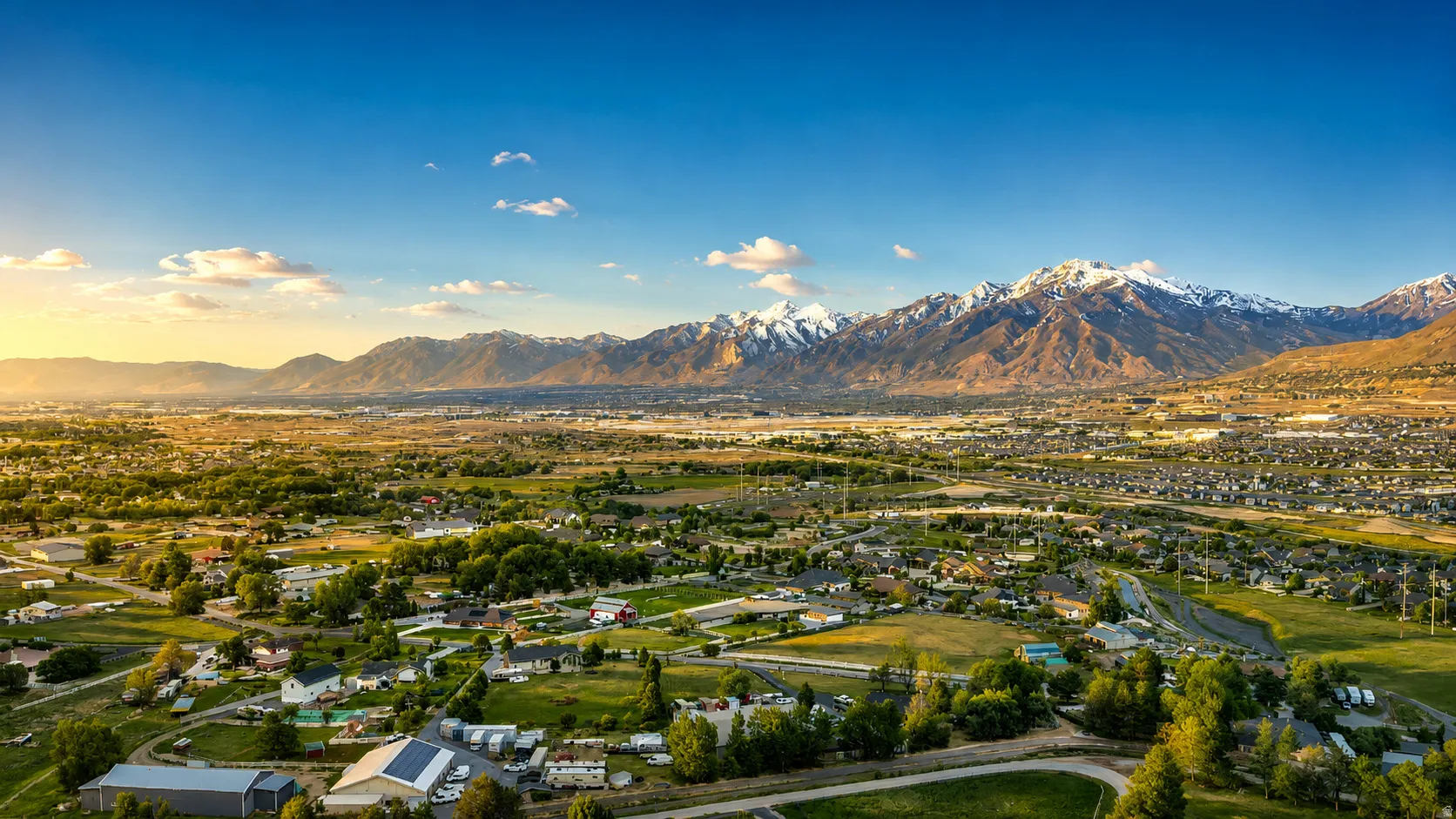 Expansive landscape showcasing a broad valley and distant snow-capped mountains