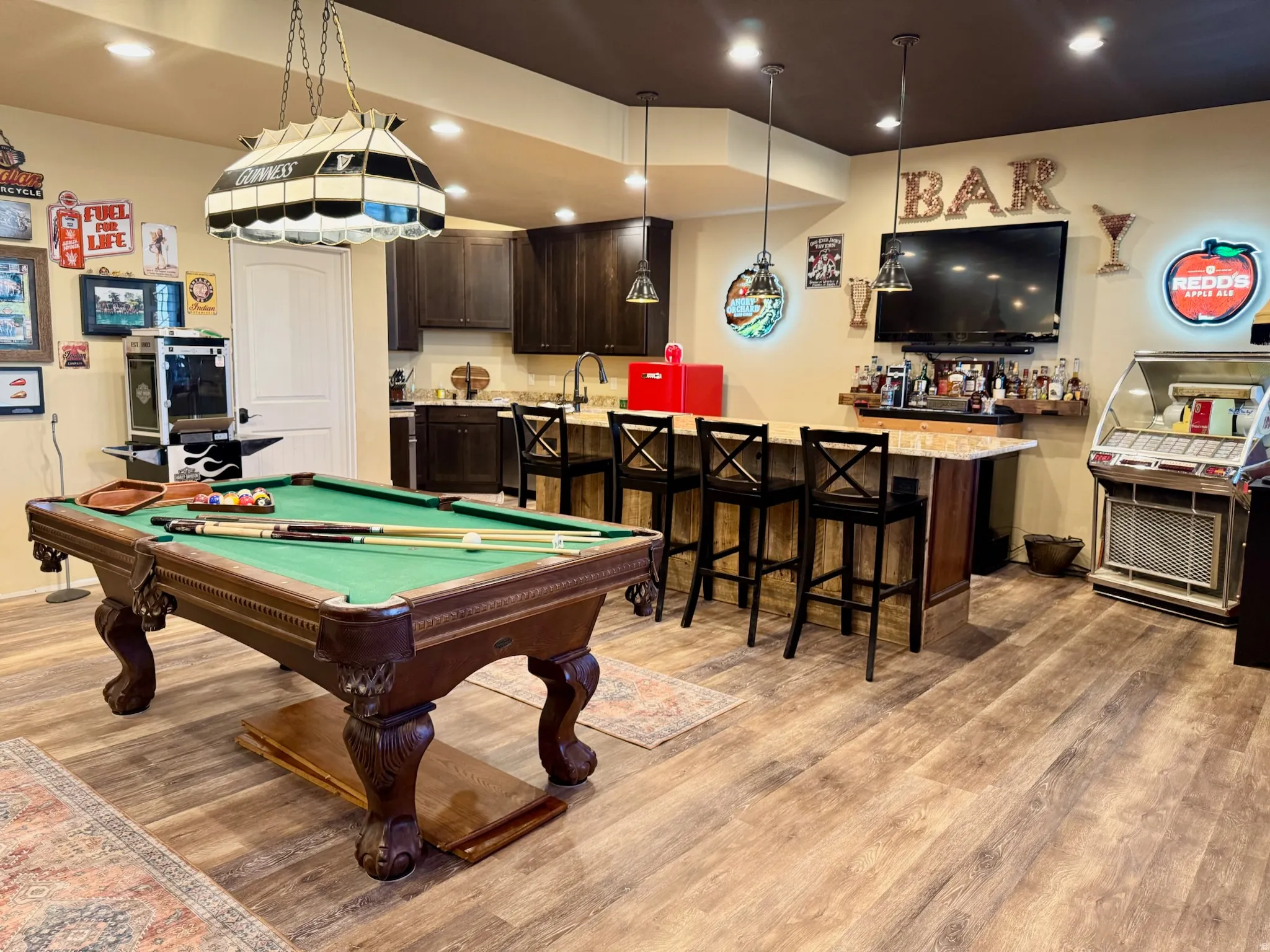 Game room featuring light wood-type flooring, pool table, recessed lighting, and bar