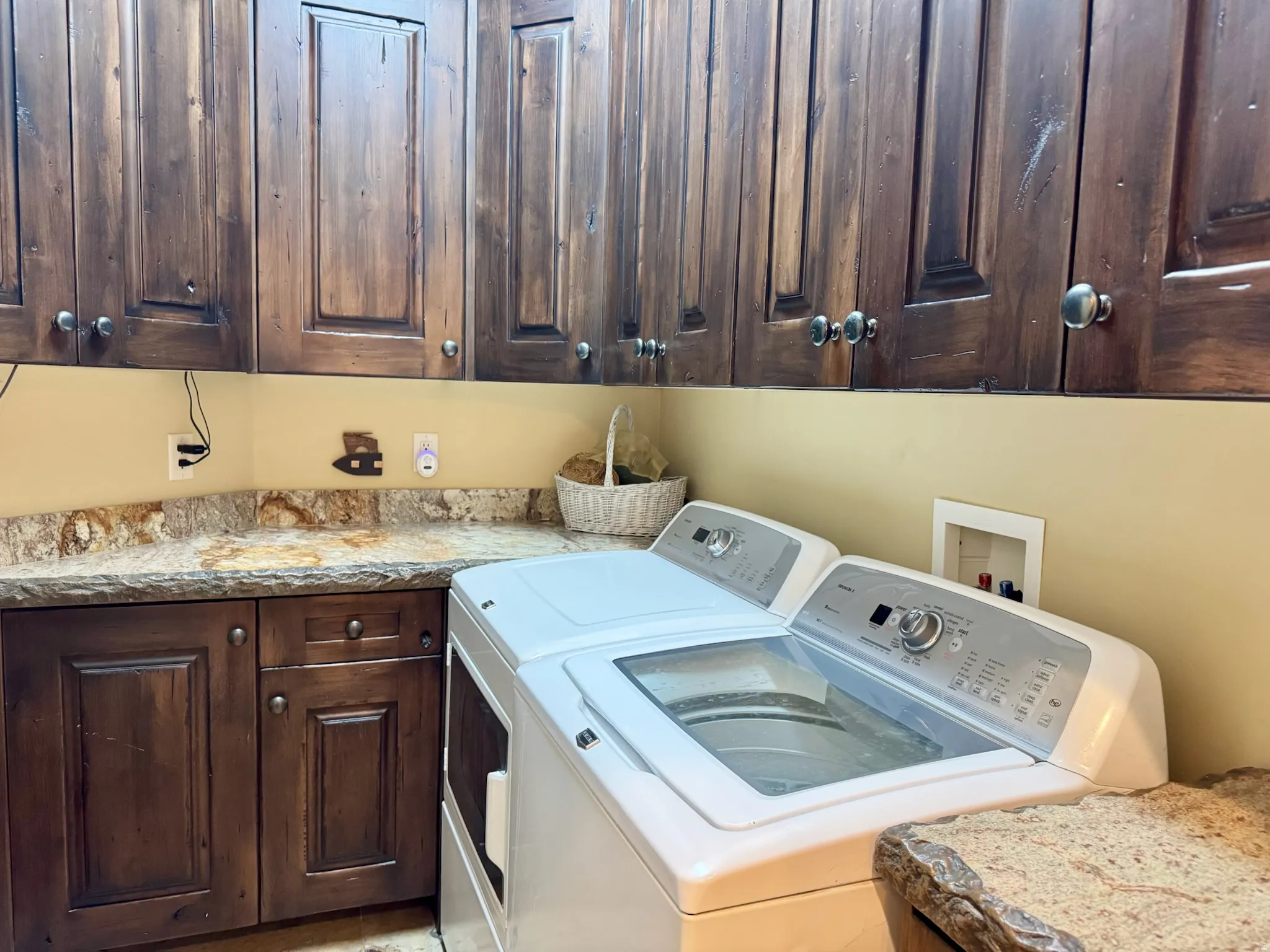 Laundry area with cabinet space and washer and clothes dryer