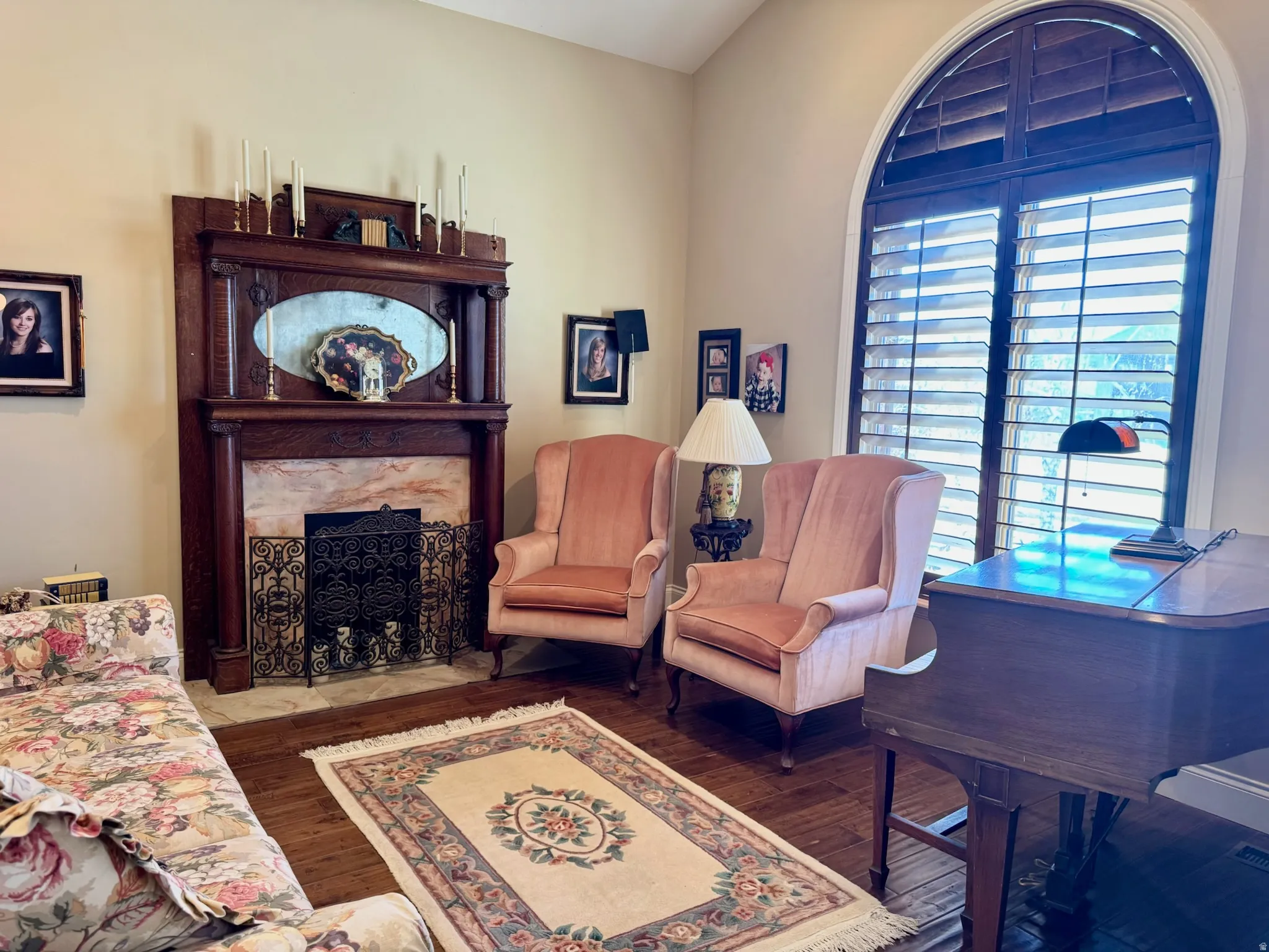 Living area featuring a high end fireplace and dark wood-style flooring