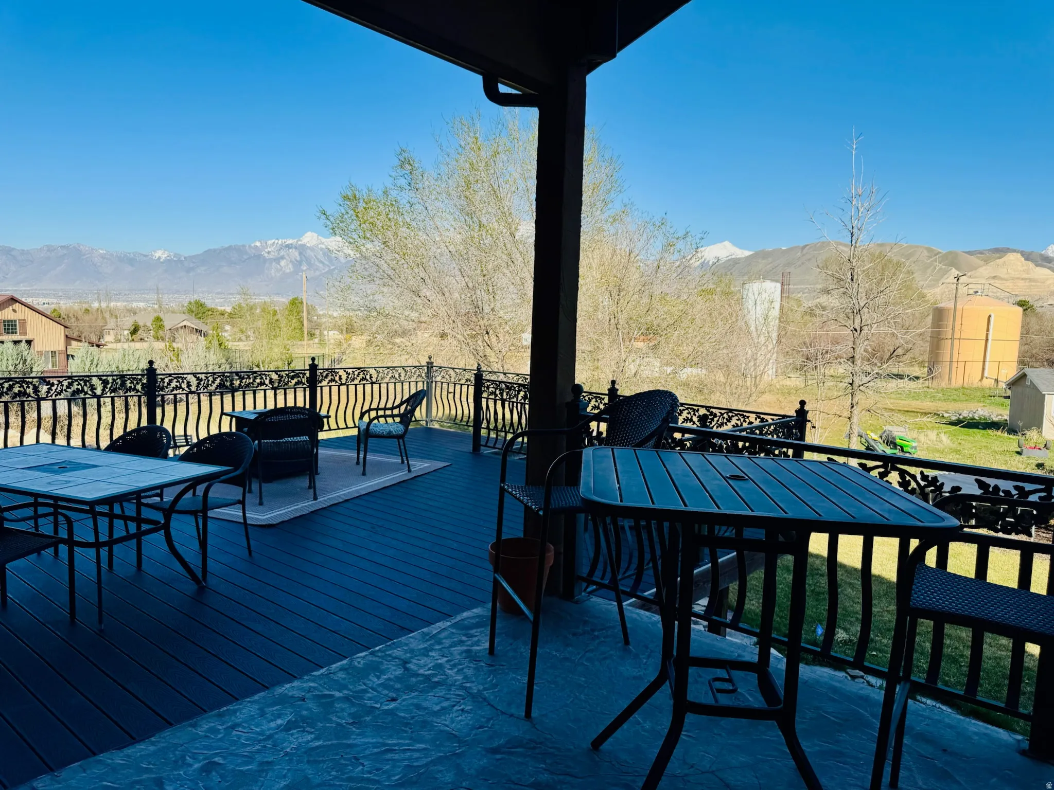 Wooden deck with a mountain view, outdoor dining space, and a grill