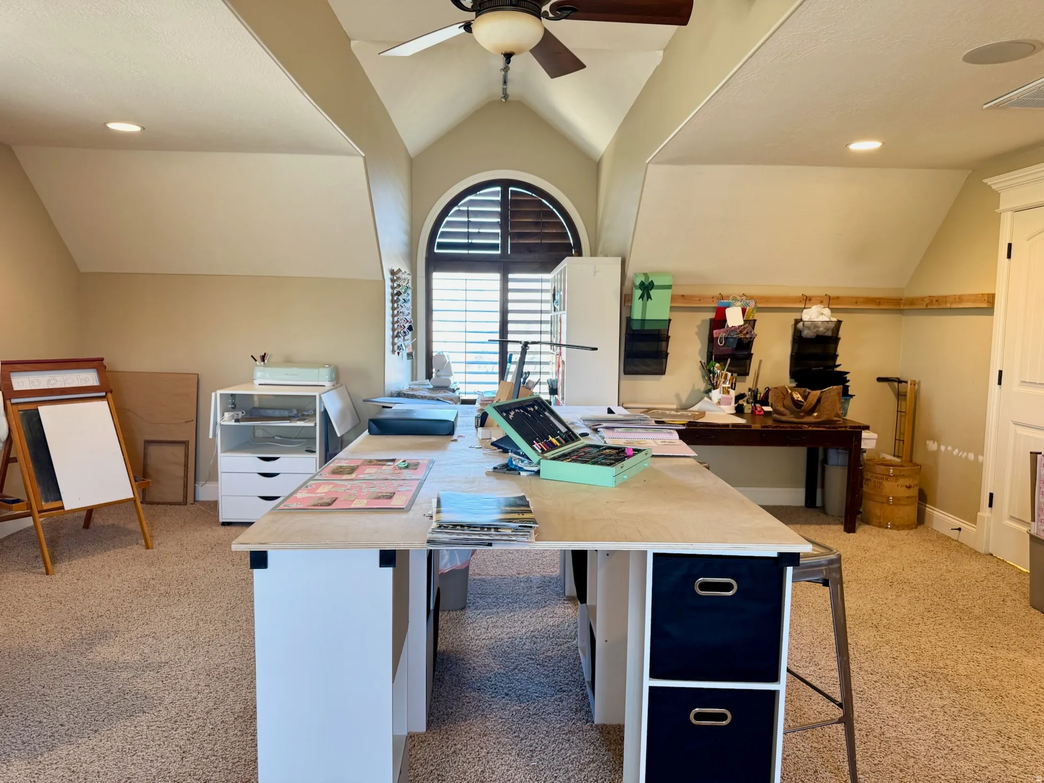 Office space featuring vaulted ceiling, light colored carpet, a ceiling fan, and recessed lighting