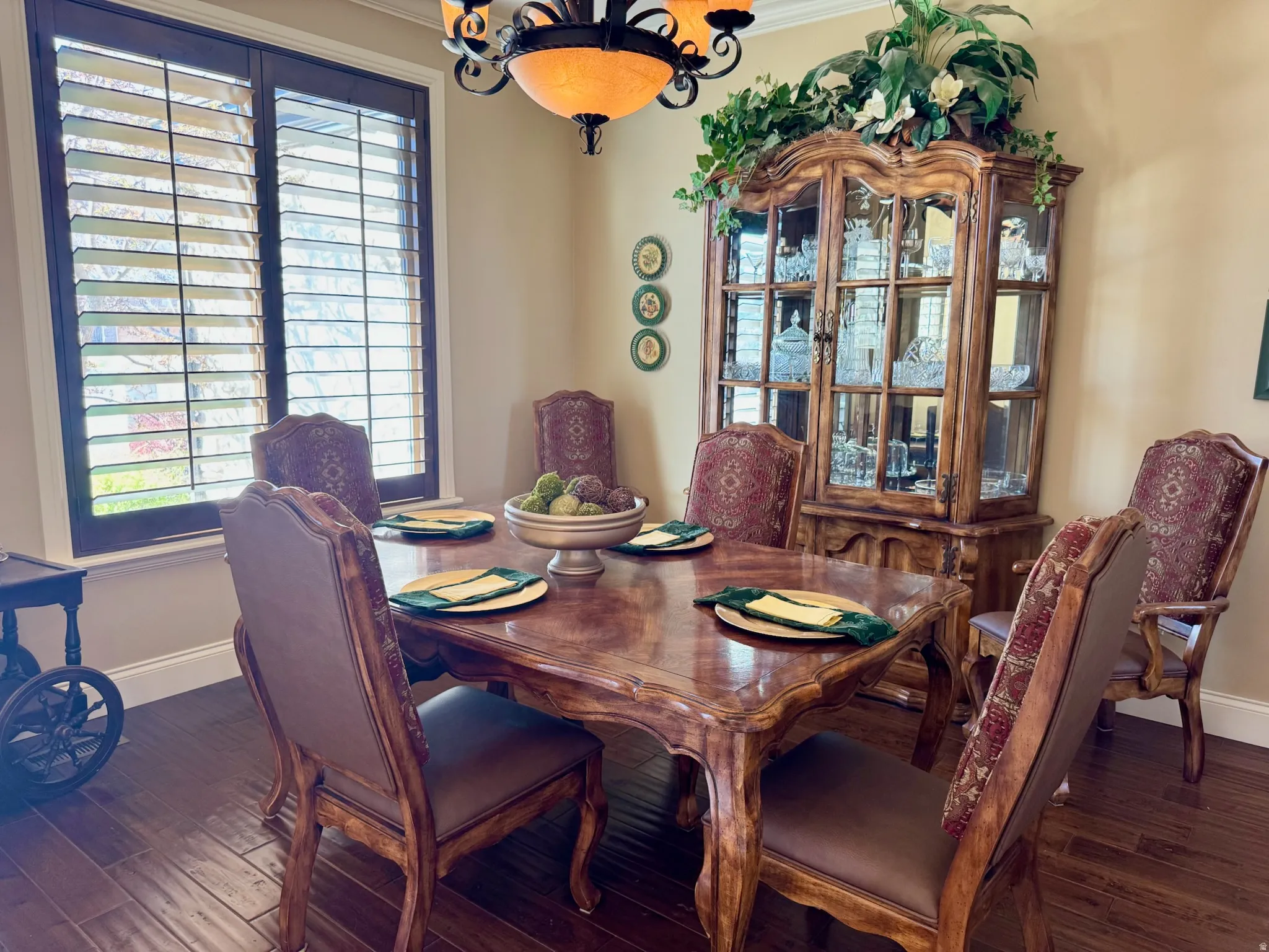 Dining area featuring hanging lights, hardwood / wood-style floors, and ornamental molding