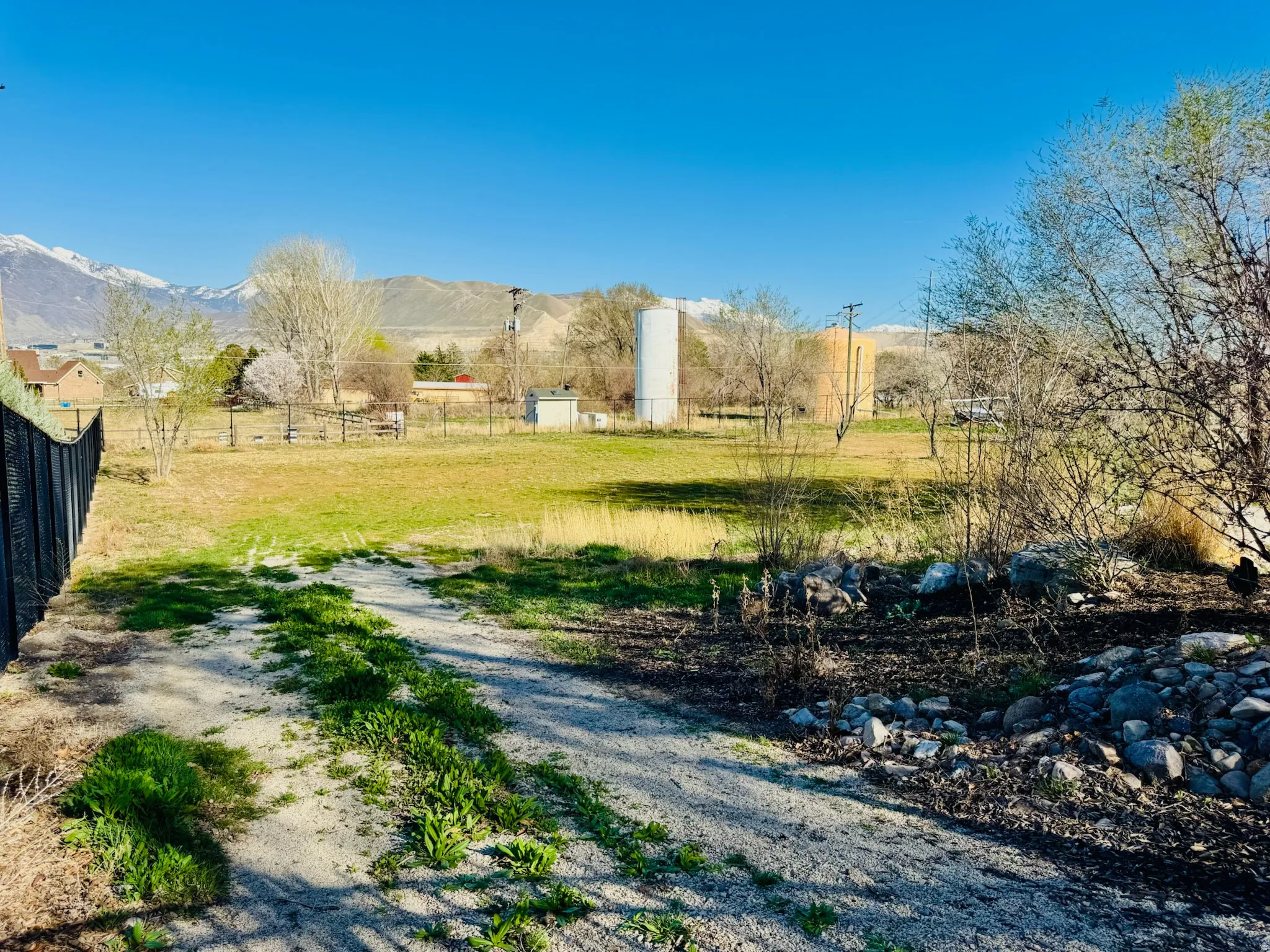 View of dirt / gravel road with a rural view and a mountain view