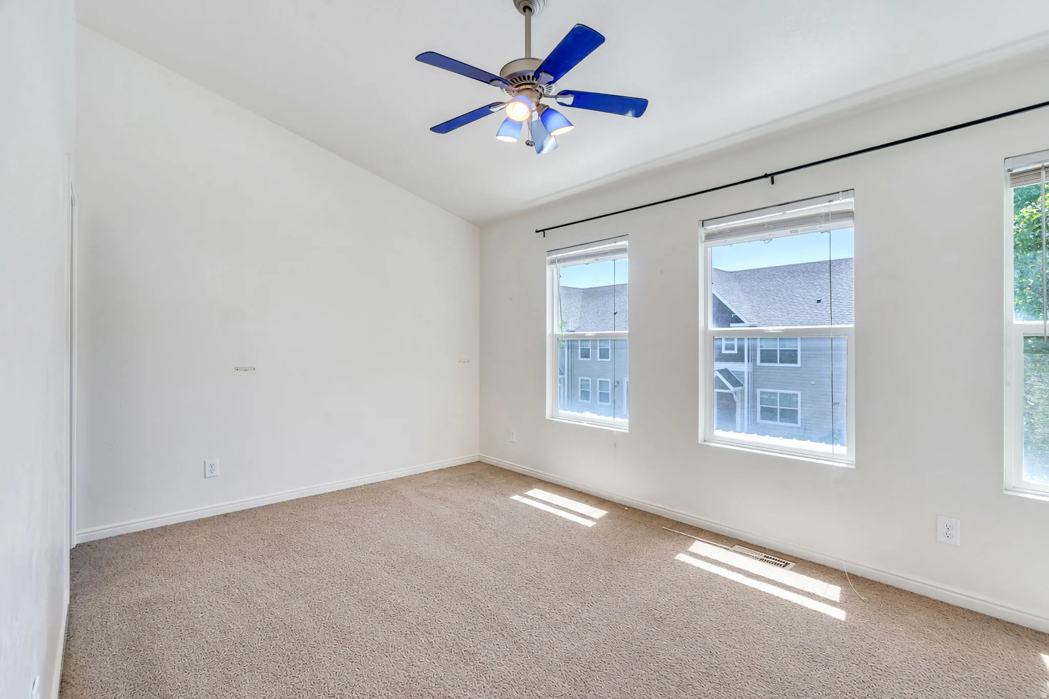 South bedroom with three windows and ceiling fan with light fixture