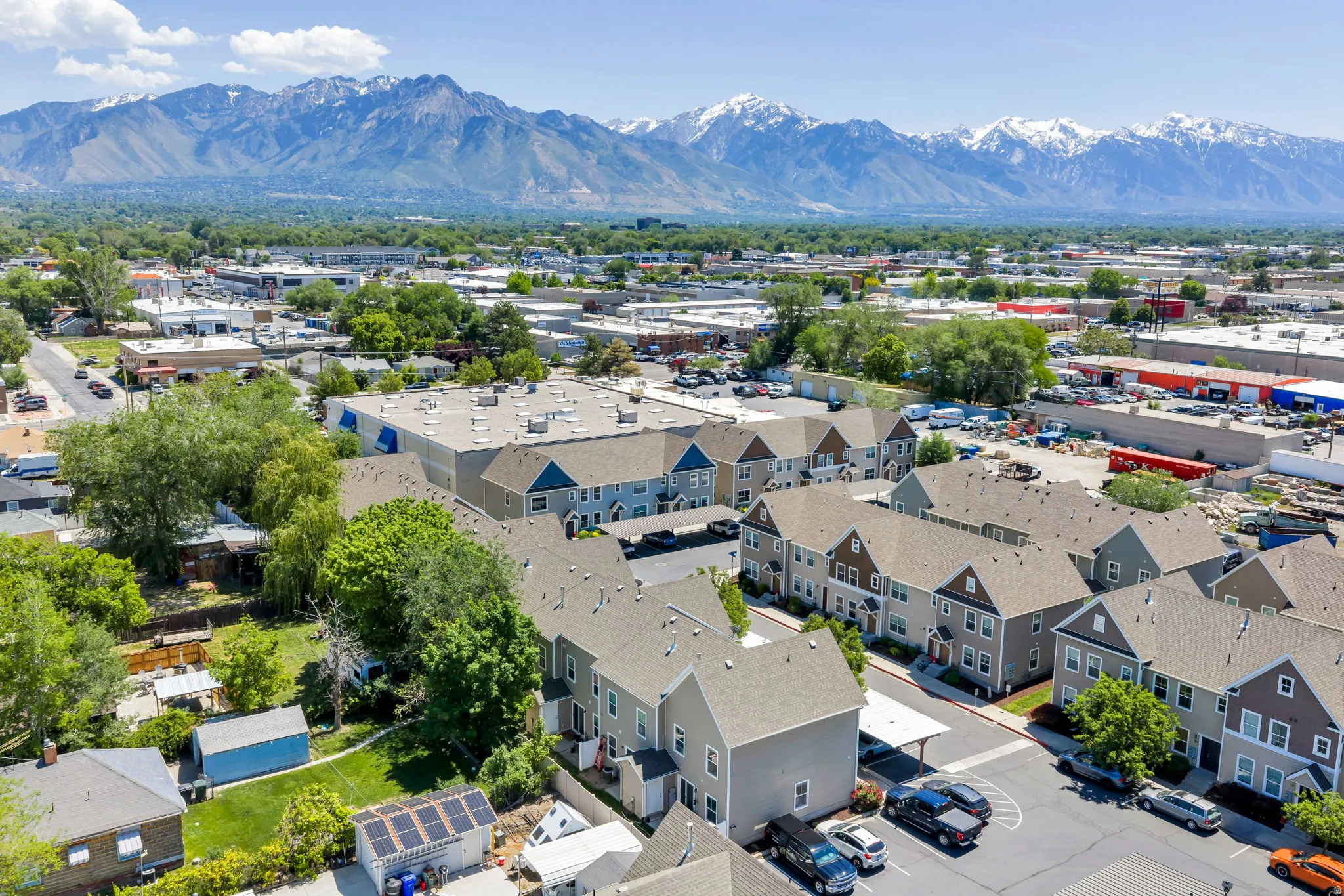 Row of multi-story residential buildings with covered parking areas