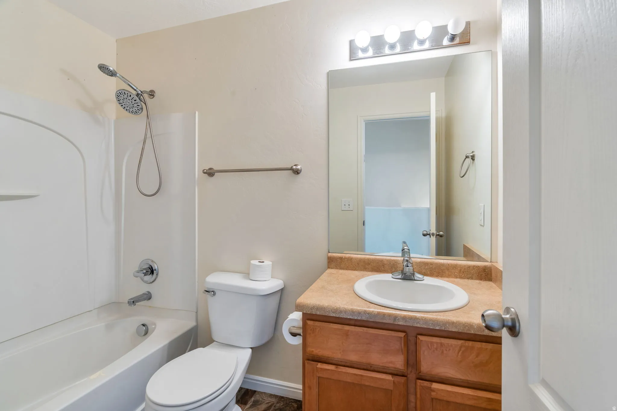 Bathroom featuring a tub/shower combination with chrome fixtures and a detachable showerhead