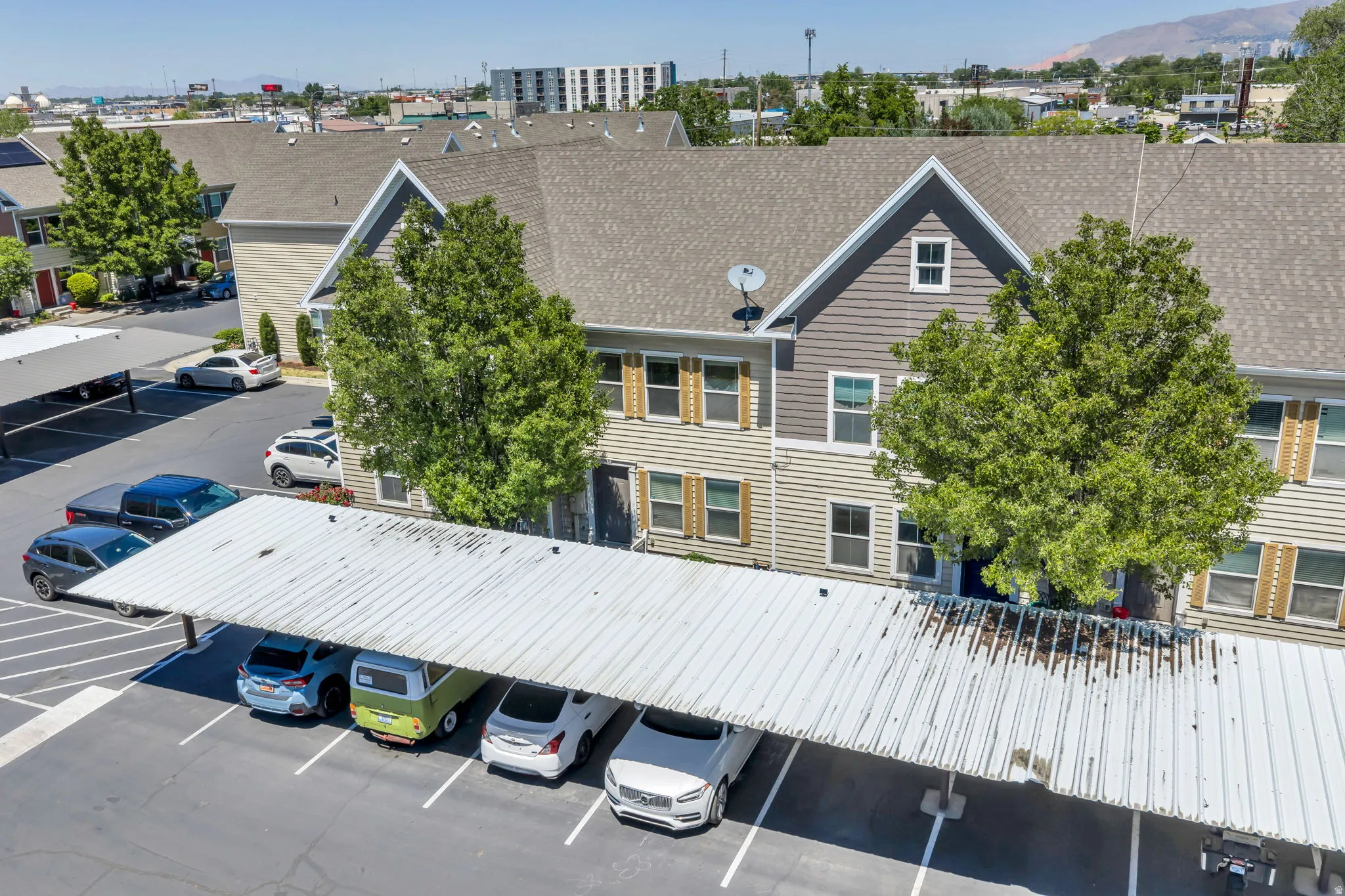 Multi-level townhouse-style residences with pitched shingle roofs and mixed siding exteriors