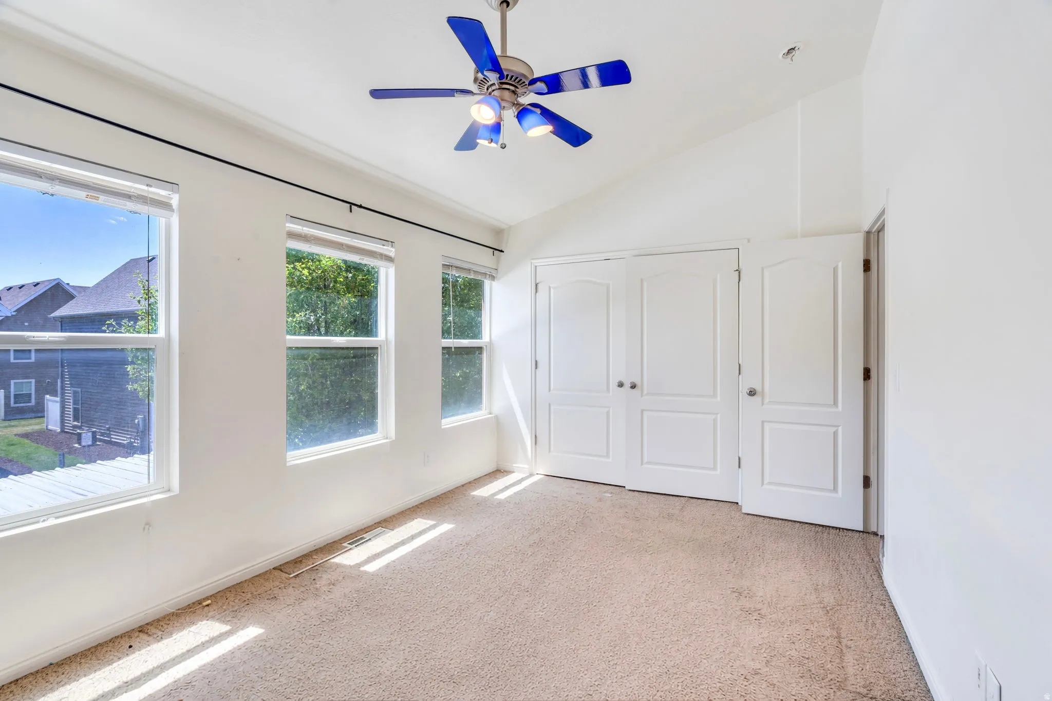 South bedroom with three windows and ceiling fan with light fixture