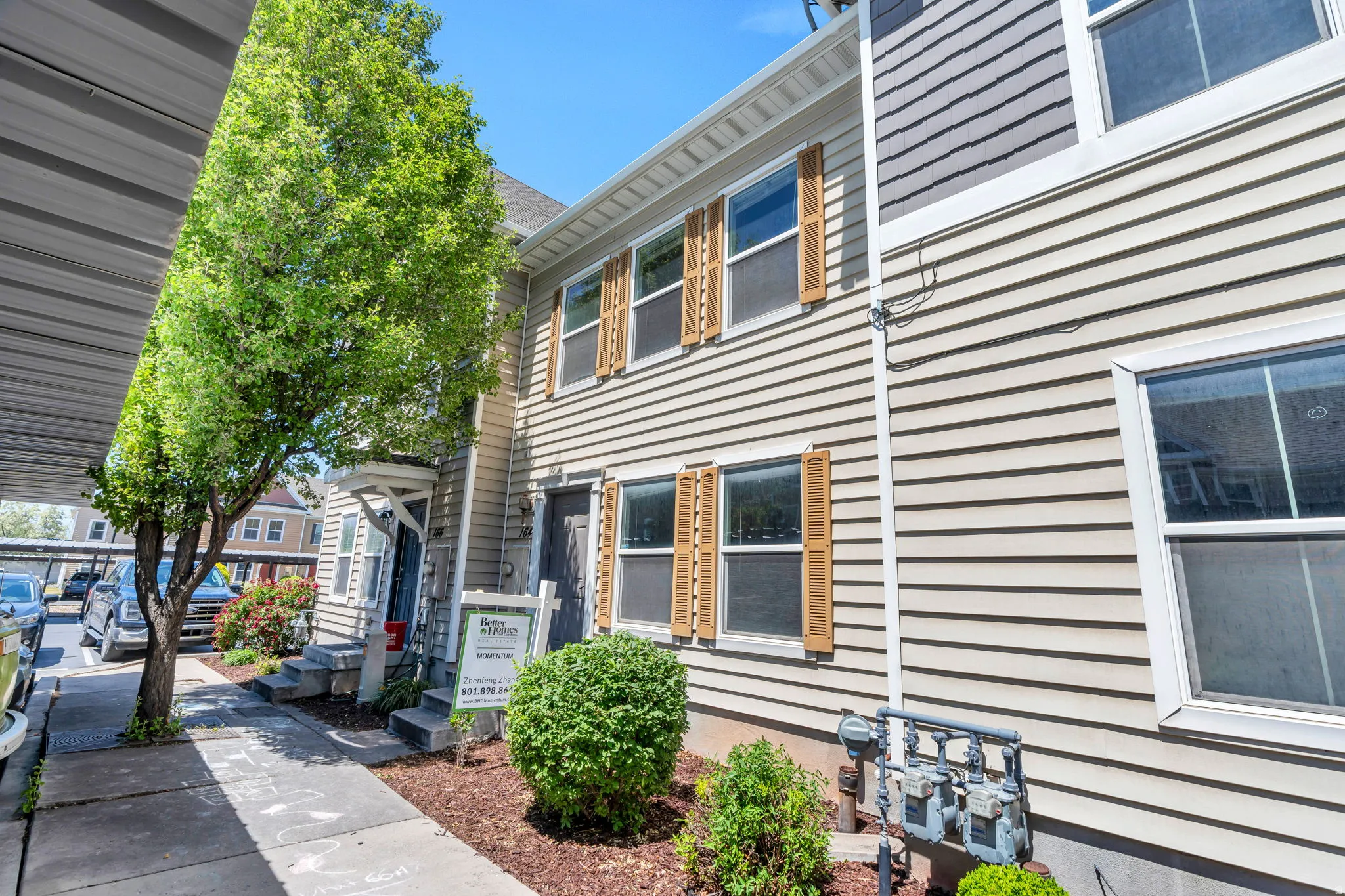 Two-story exterior featuring horizontal siding and contrasting window shutters