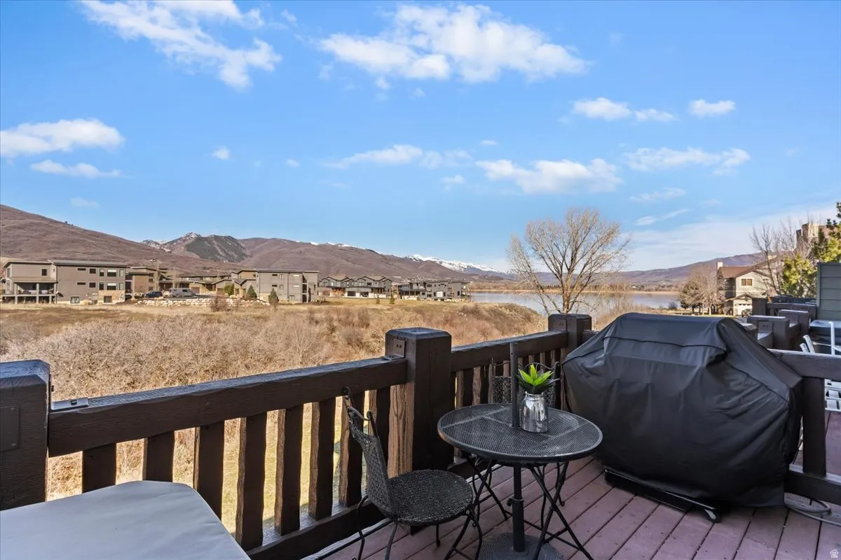 Deck with a grill, a mountain view, and a residential view