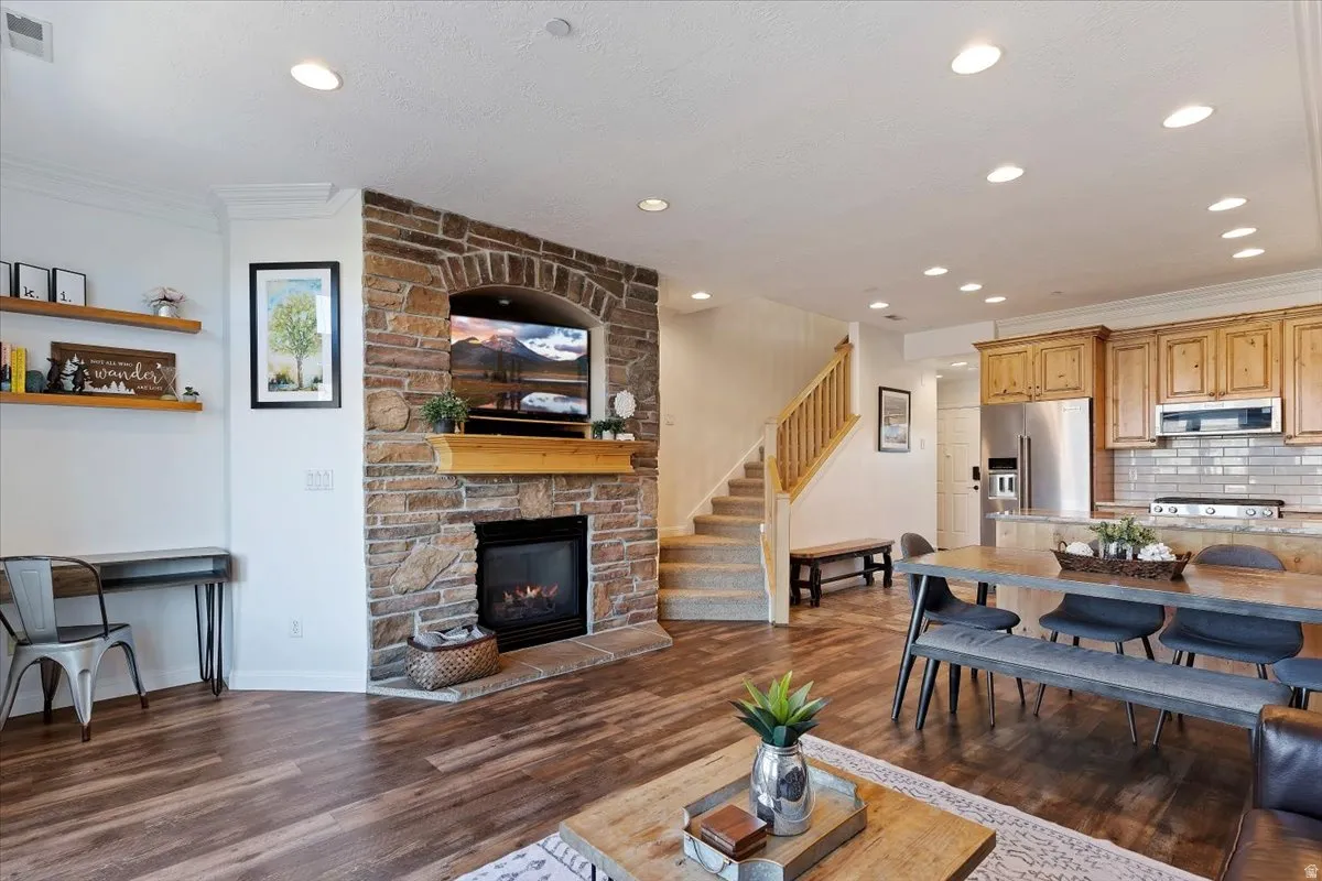 Open concept main living with stone fireplace and updated kitchen and floors.