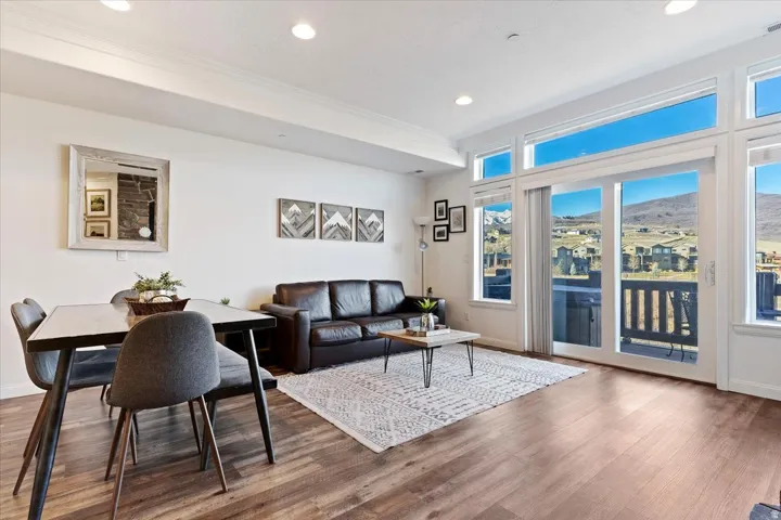 Living area with wood finished floors, a mountain view, recessed lighting, and crown molding