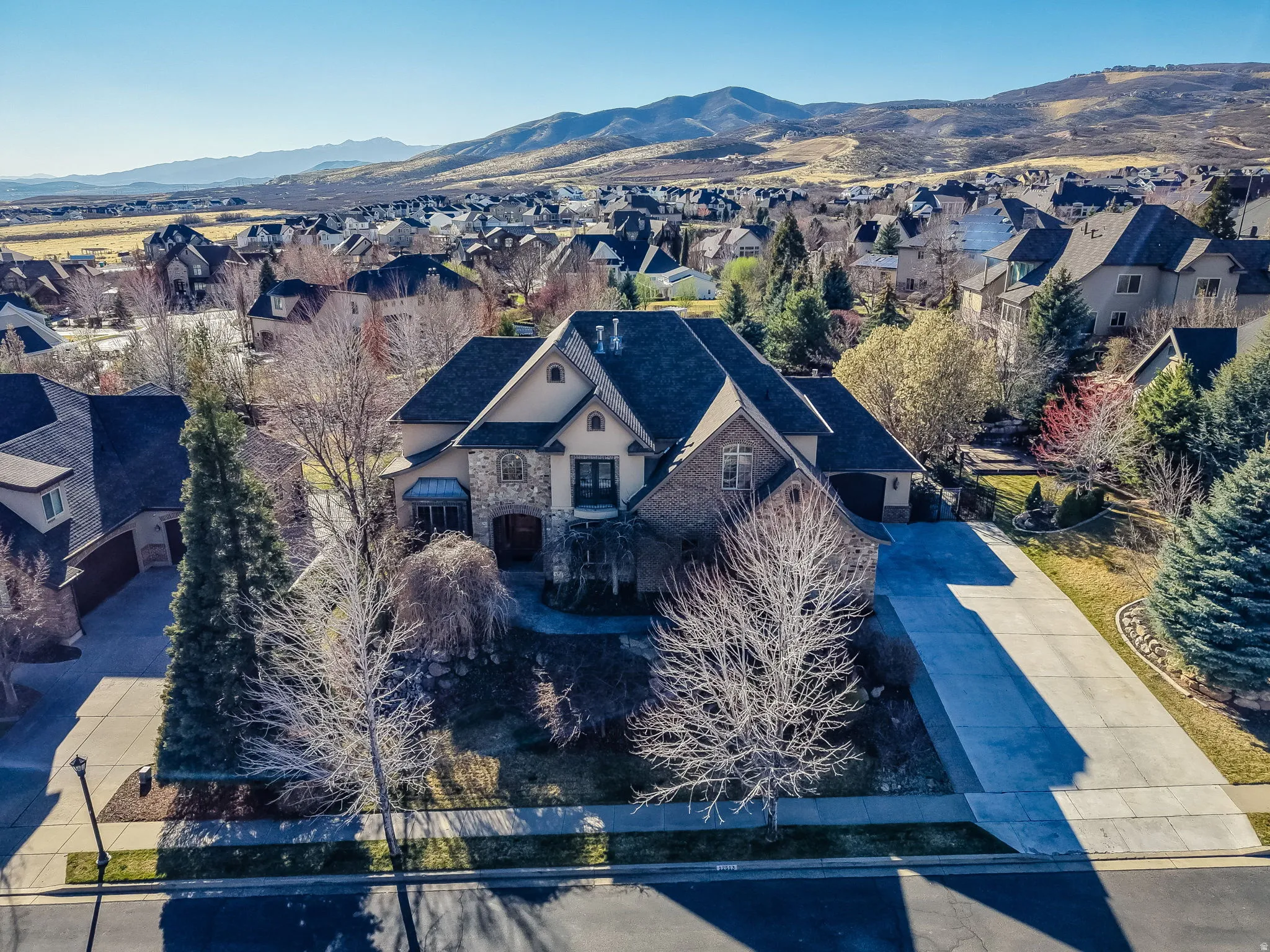 Aerial perspective of suburban area featuring a mountain backdrop