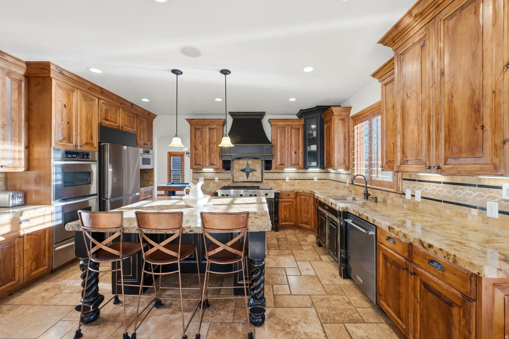 Kitchen with a breakfast bar area, a kitchen island, wood finish cabinets, and backsplash