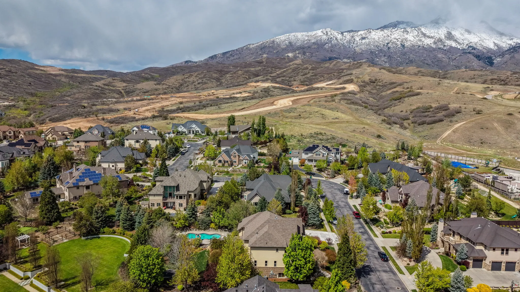 Aerial perspective of suburban area with a mountainous background