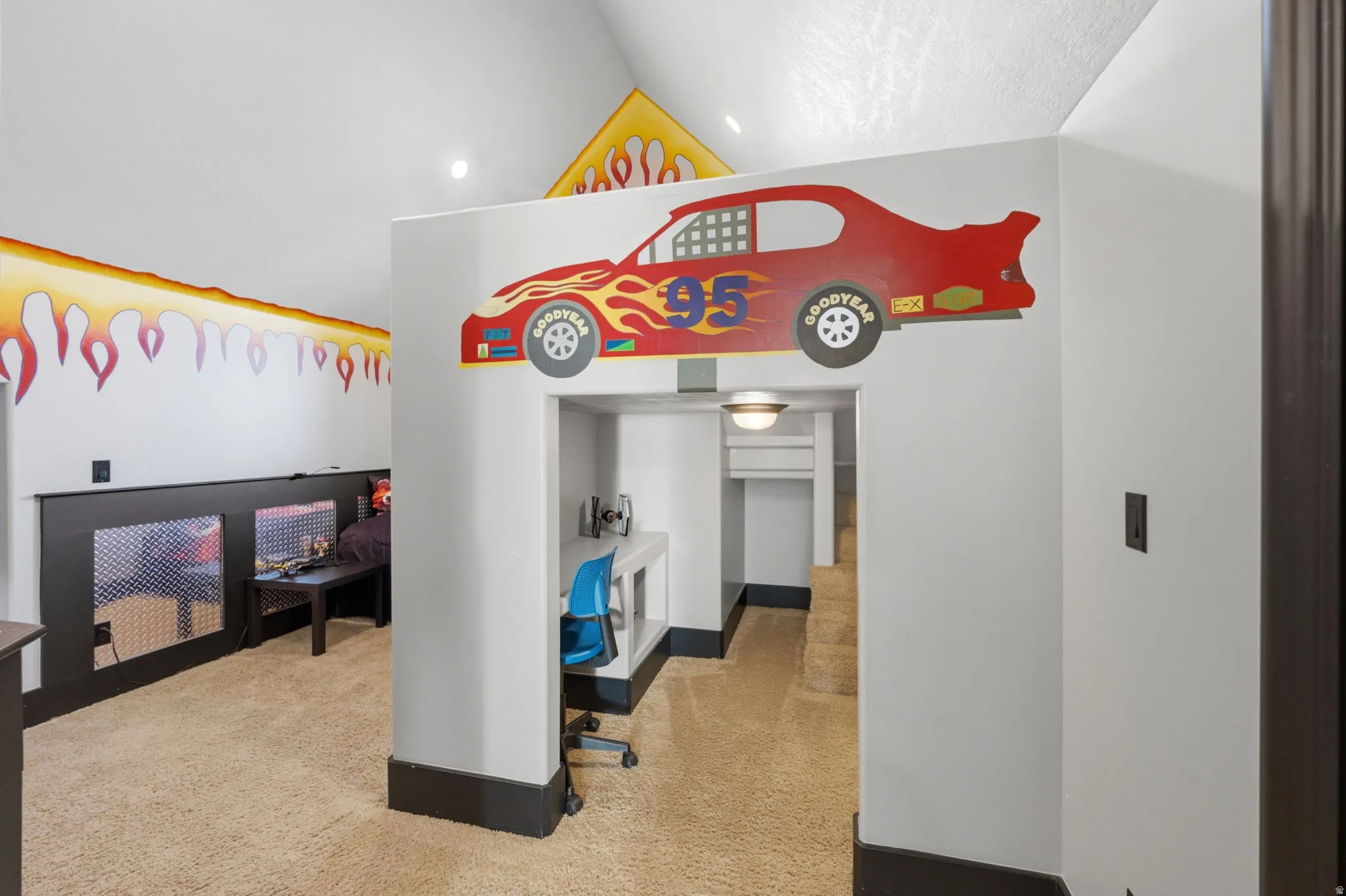 Bedroom featuring light colored carpet and vaulted ceiling