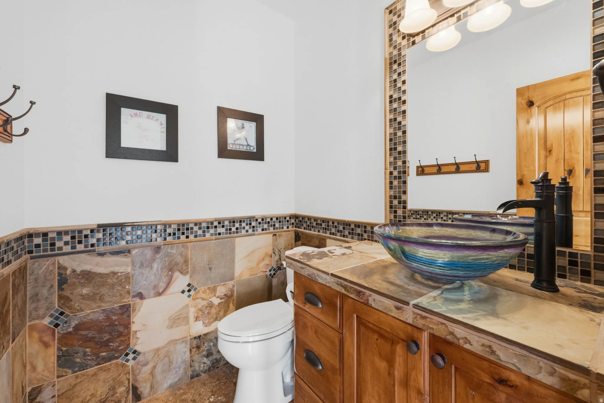 Bathroom with vanity, tile walls, and wainscoting
