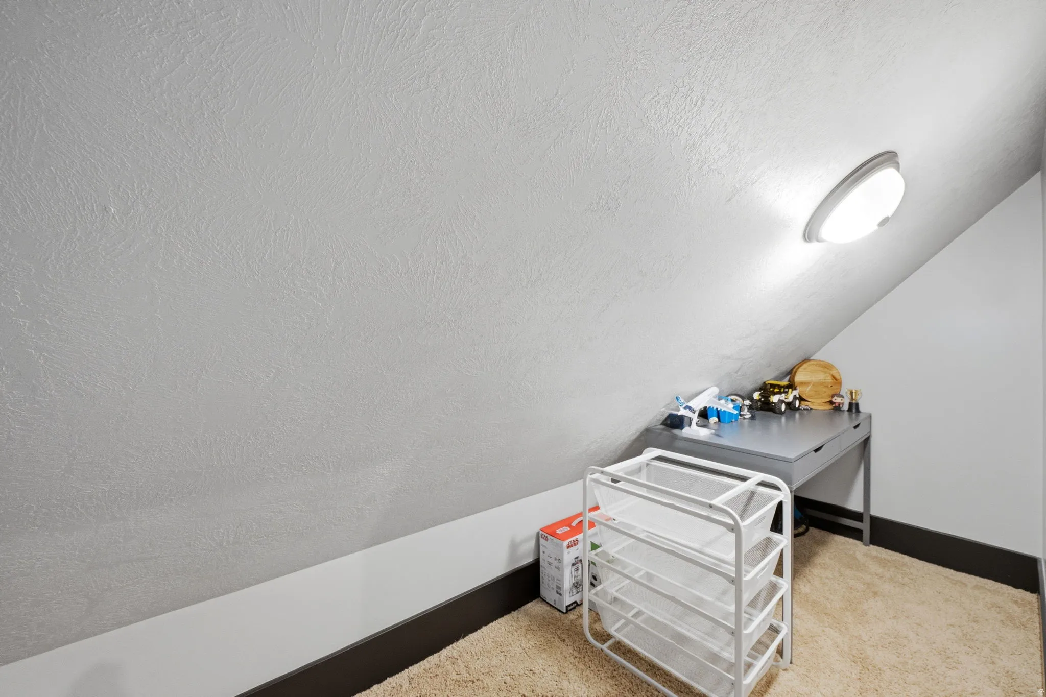 Interior space featuring carpet floors and baseboards