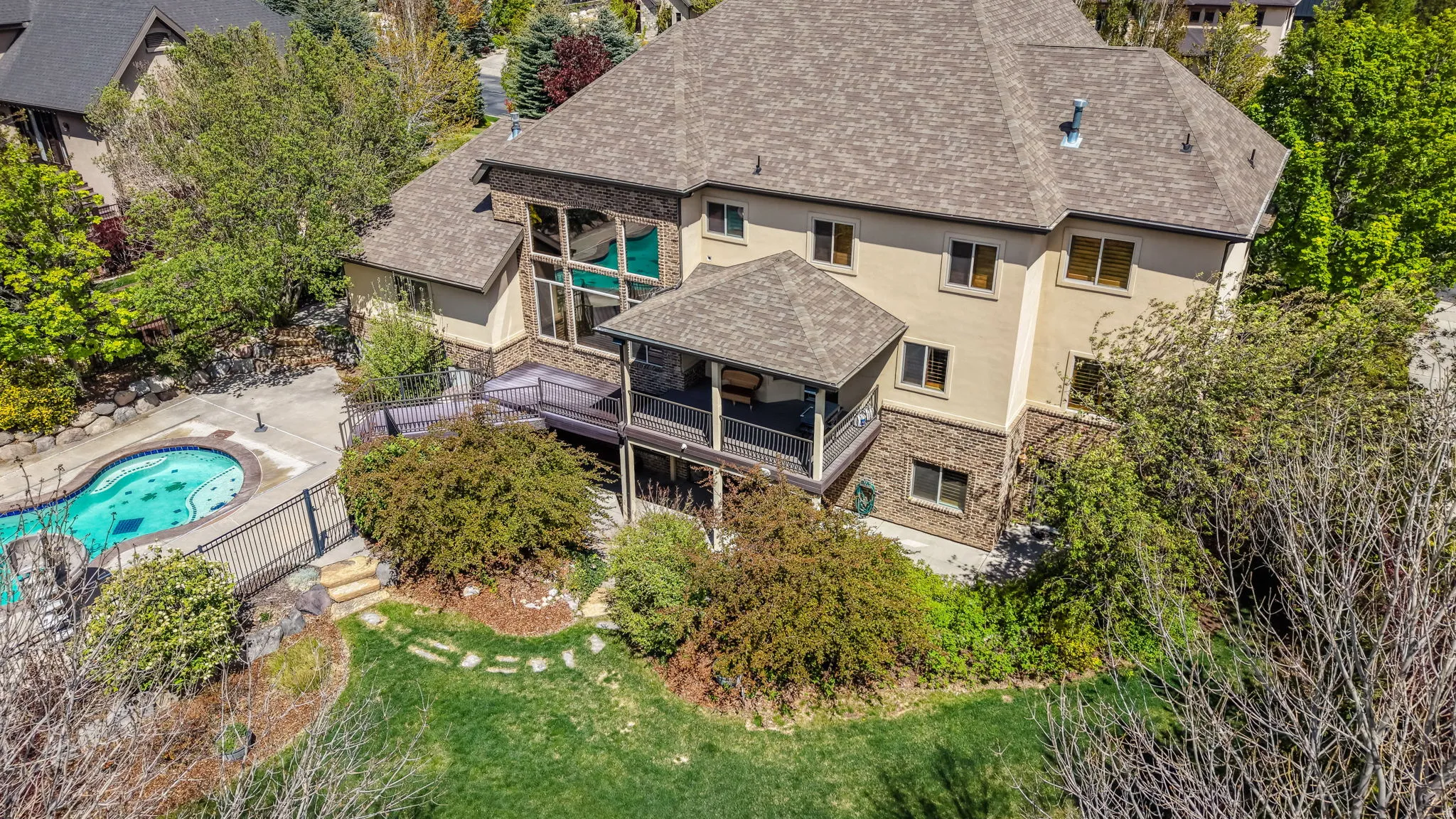 Aerial view of property and surrounding area featuring a pool