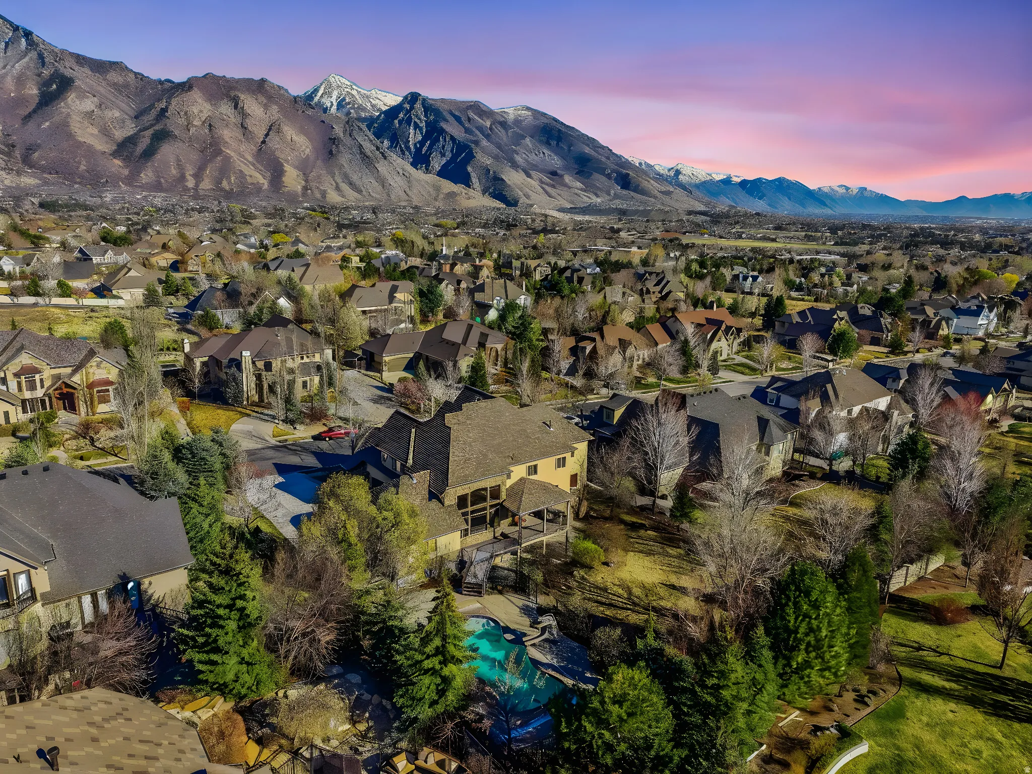 Aerial perspective of suburban area with a mountain backdrop