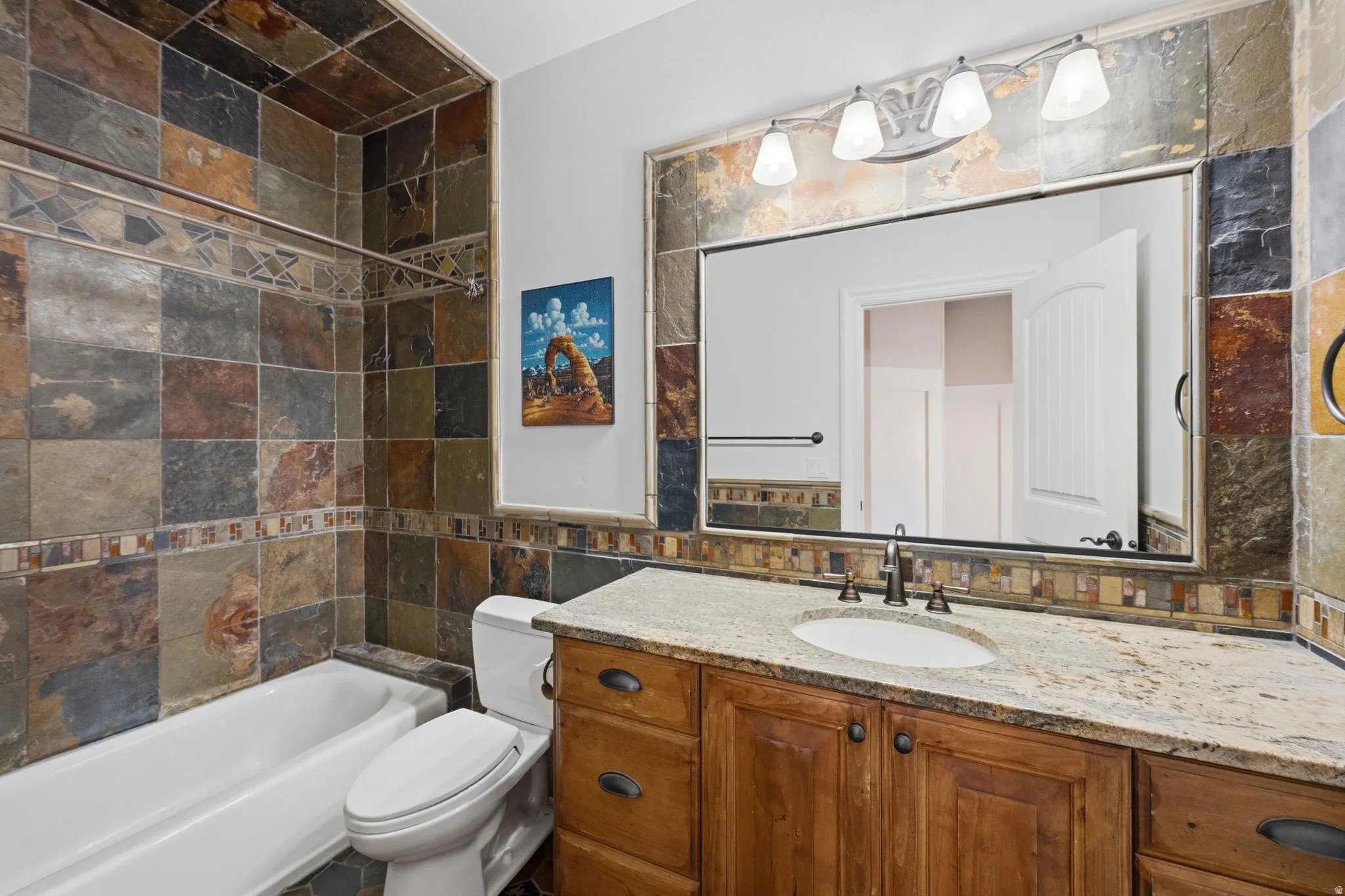 Full bath with vanity, tile walls, and bathing tub / shower combination