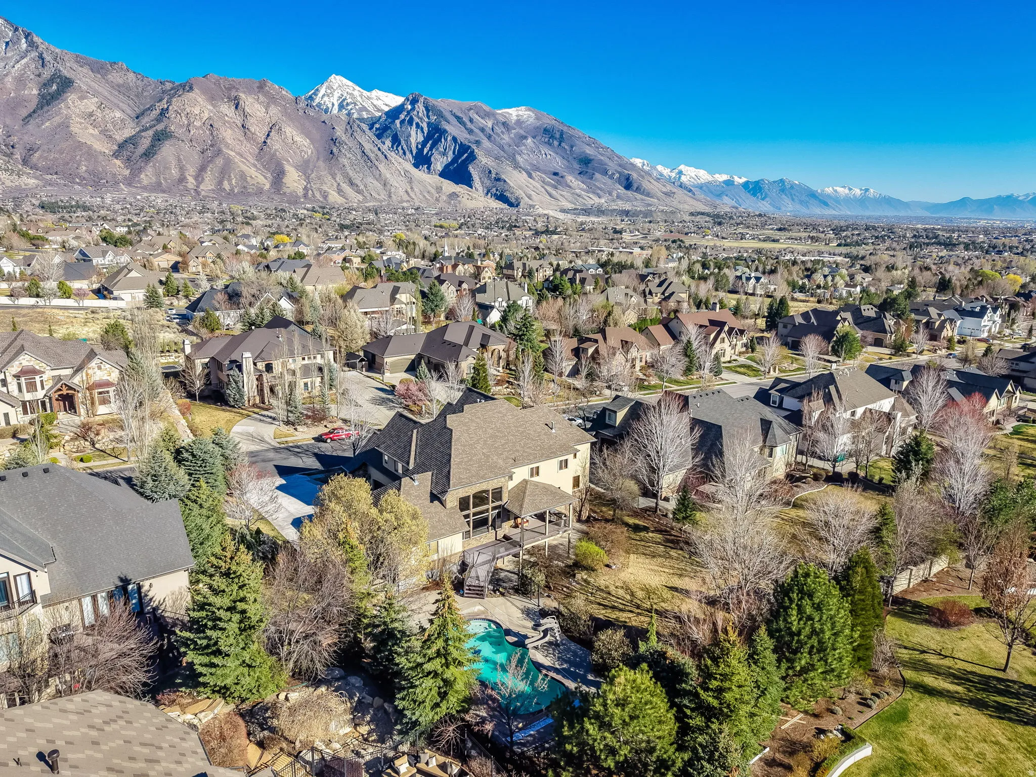 Aerial perspective of suburban area with a mountainous background