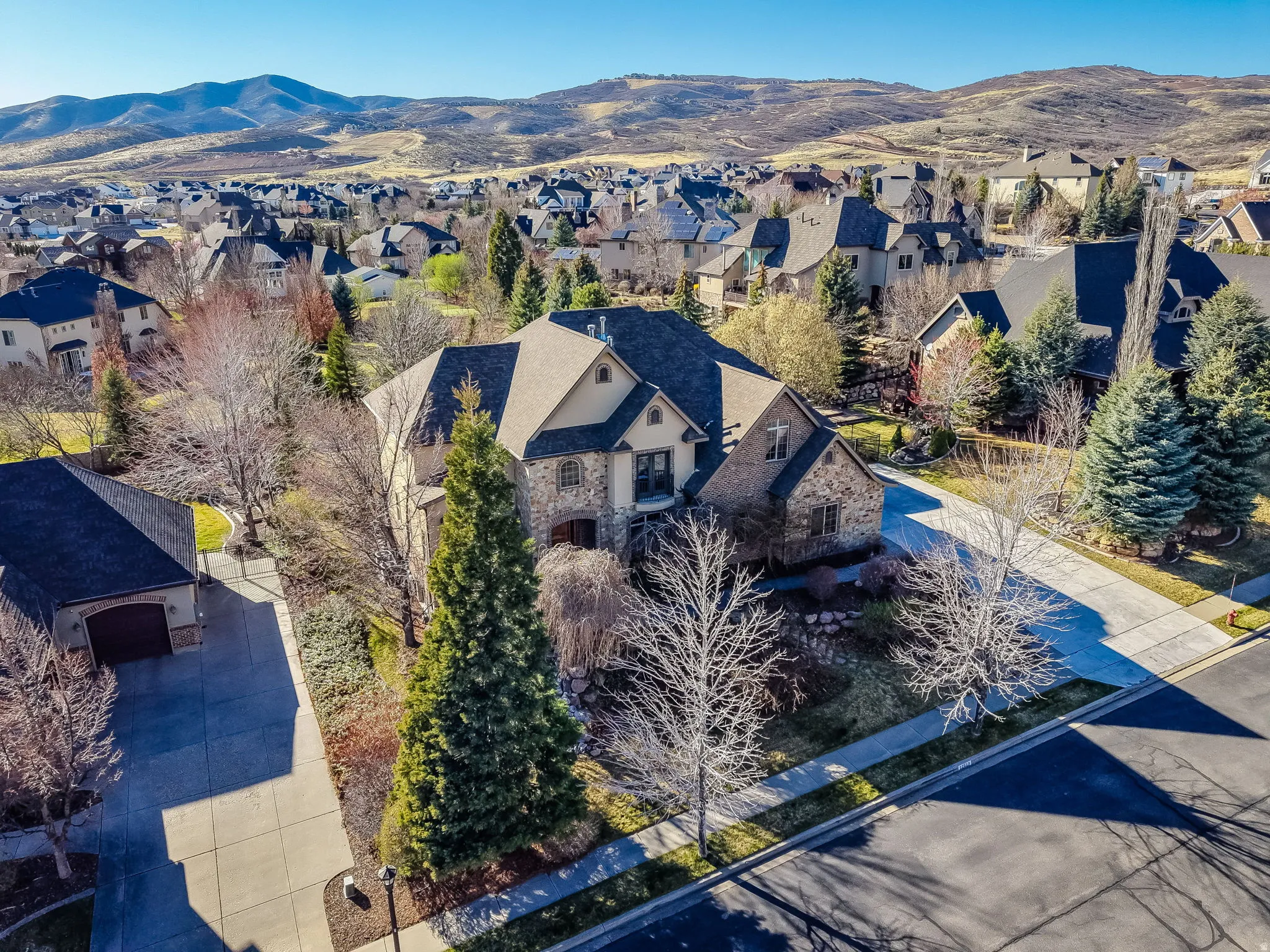 Aerial perspective of suburban area with a mountain backdrop
