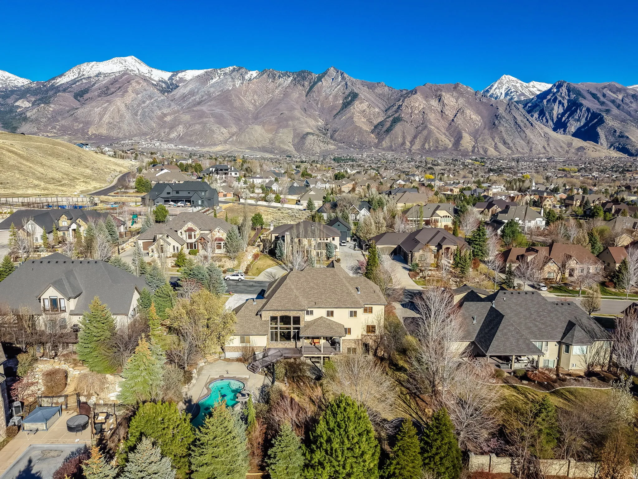 View of mountain backdrop featuring nearby suburban area