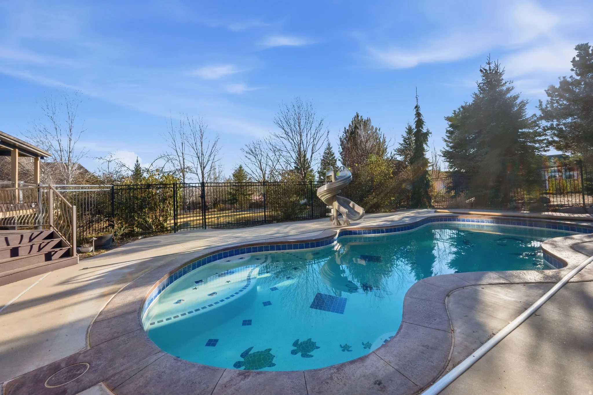 View of swimming pool featuring a fenced backyard and patio surround