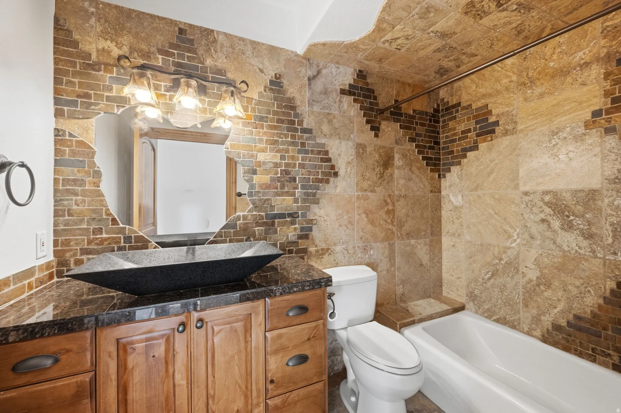 Bathroom featuring tile walls, vanity, and shower / bathtub combination