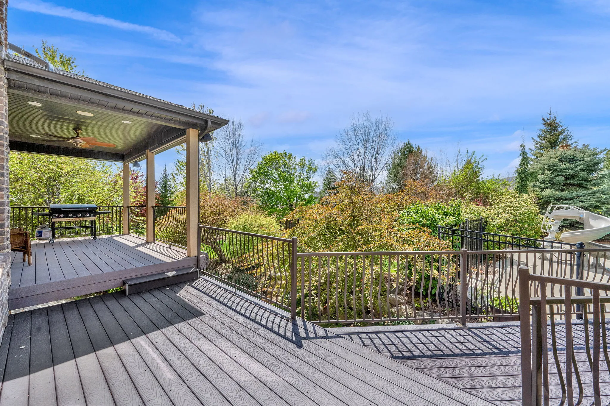 Wooden deck with ceiling fan and grilling area