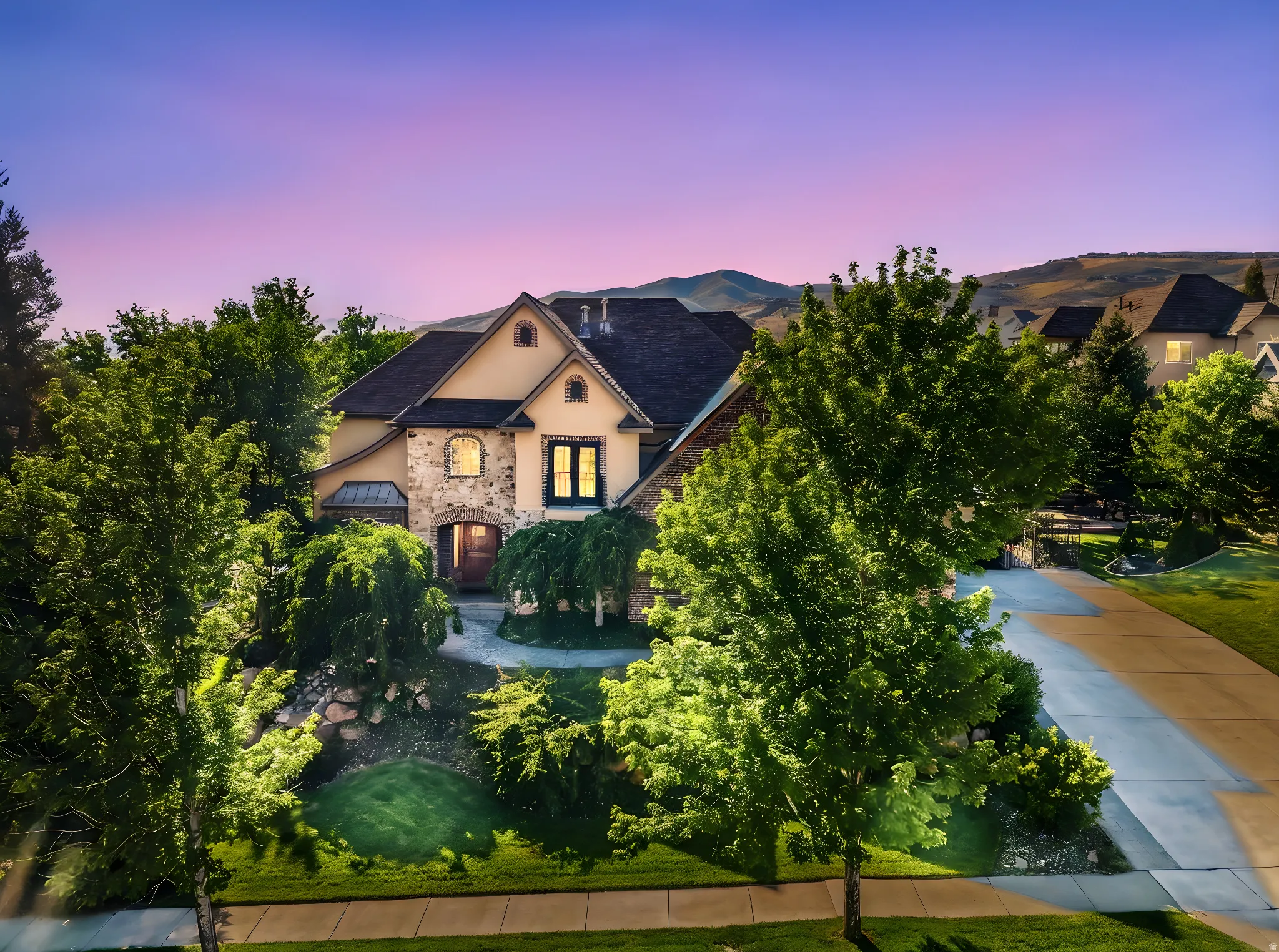 View of front facade with stucco siding and stone siding